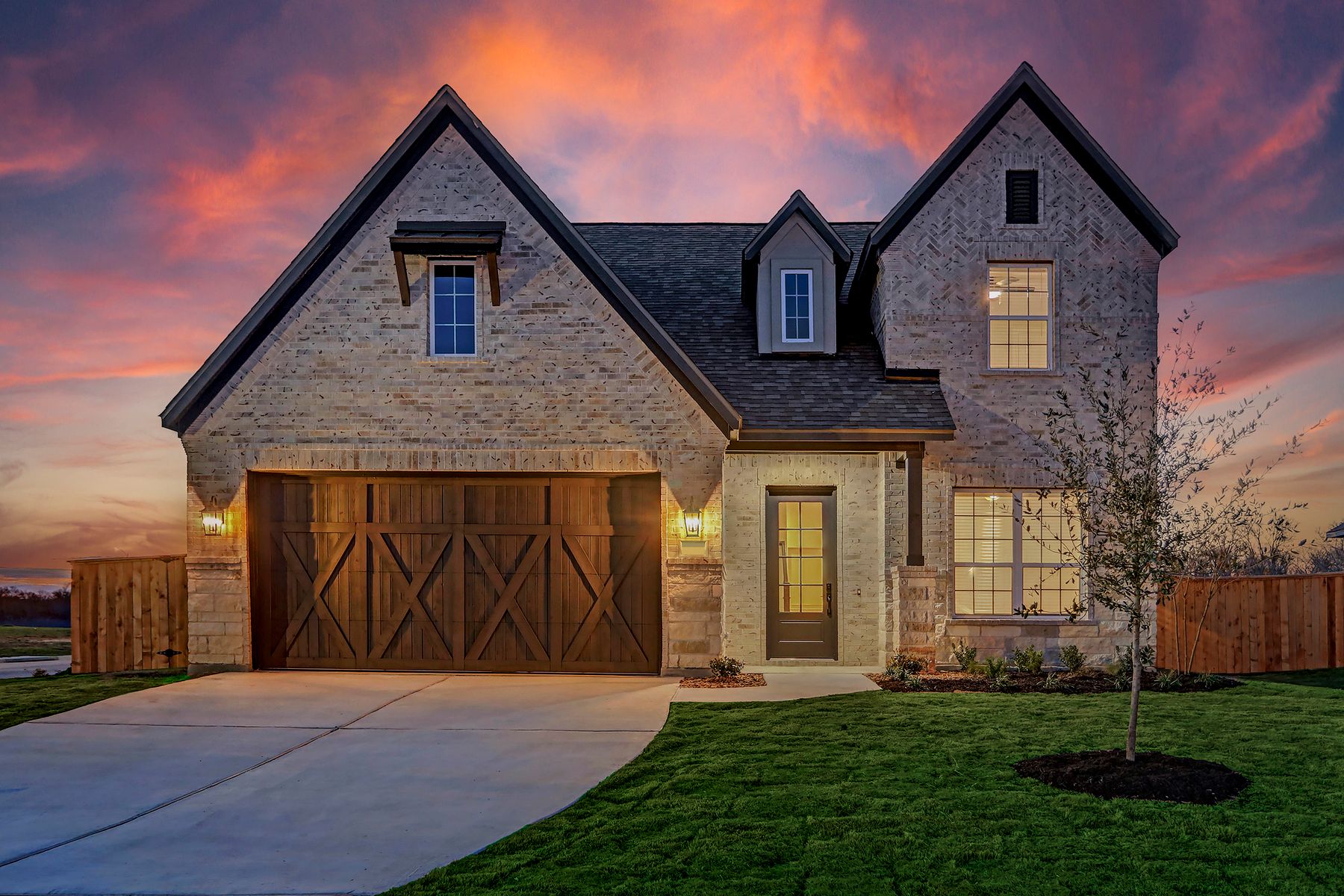 Exterior of the Jordan at dusk, highlighting the stunning details of the home.:Terrata Homes at ShadowGlen