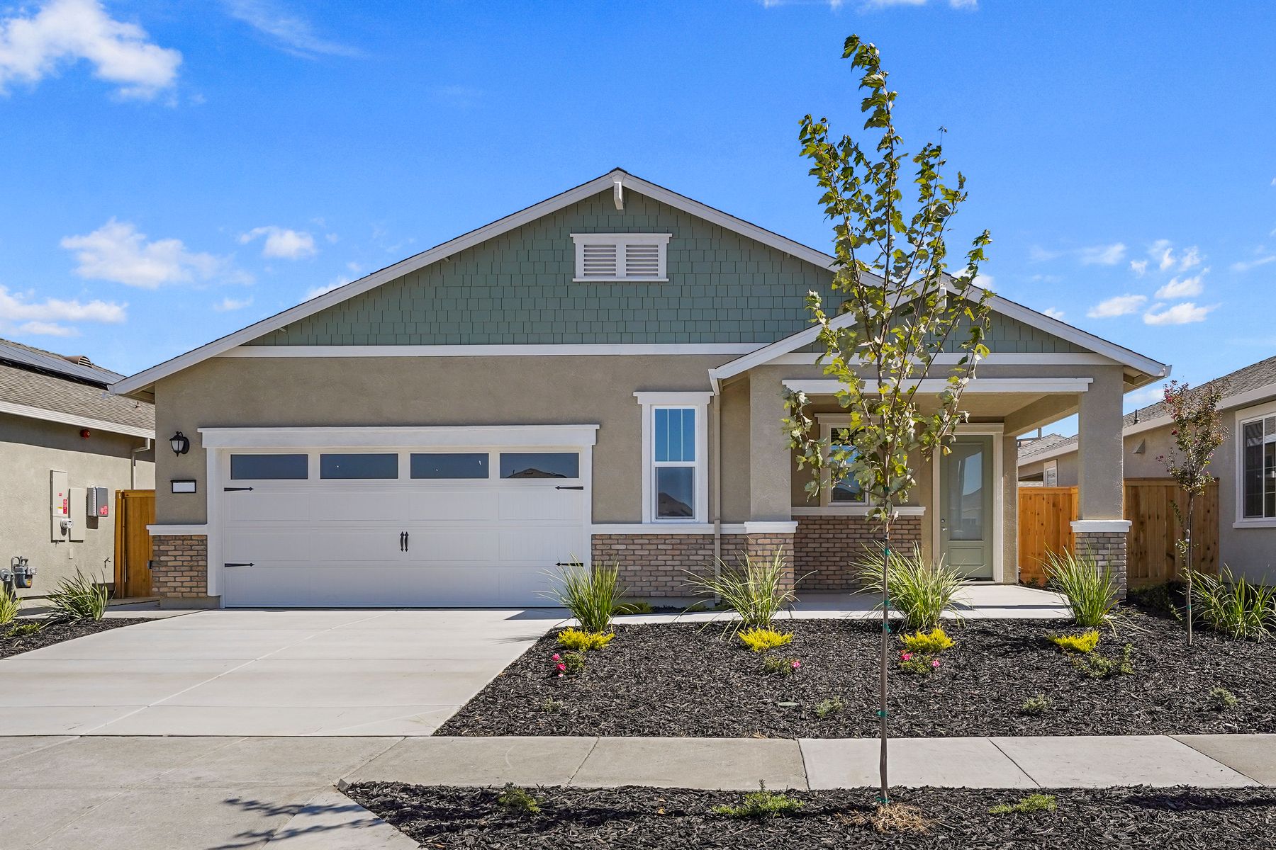 The Baldwin:This home has a 2-car garage with a mix of stone and stucco exterior features.