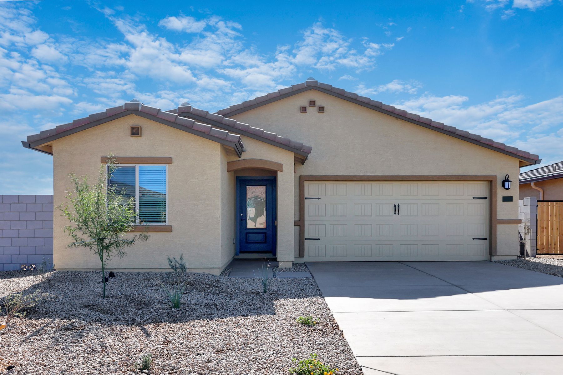 This home has a beautiful stucco exterior and features a blue door.