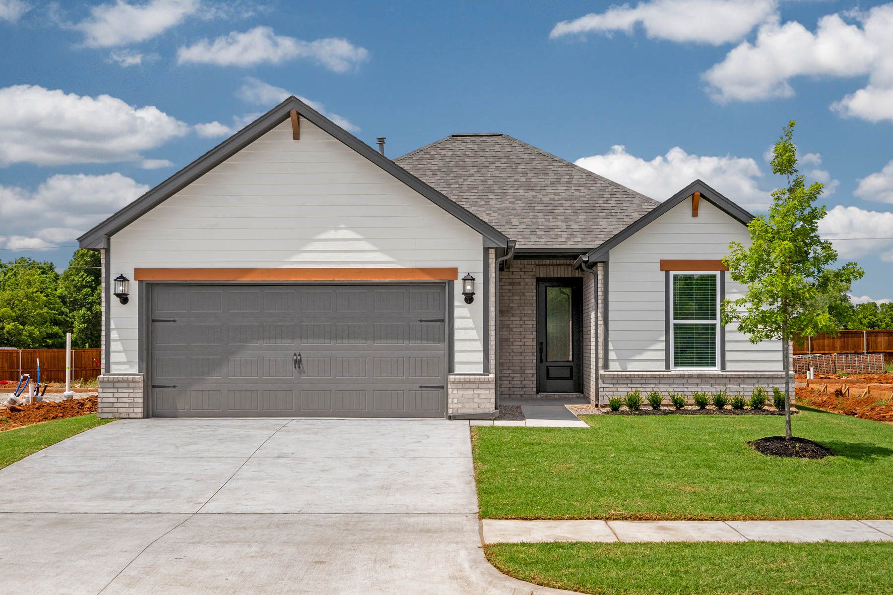The Arcadia is a beautiful one story home with a brick and siding exterior.