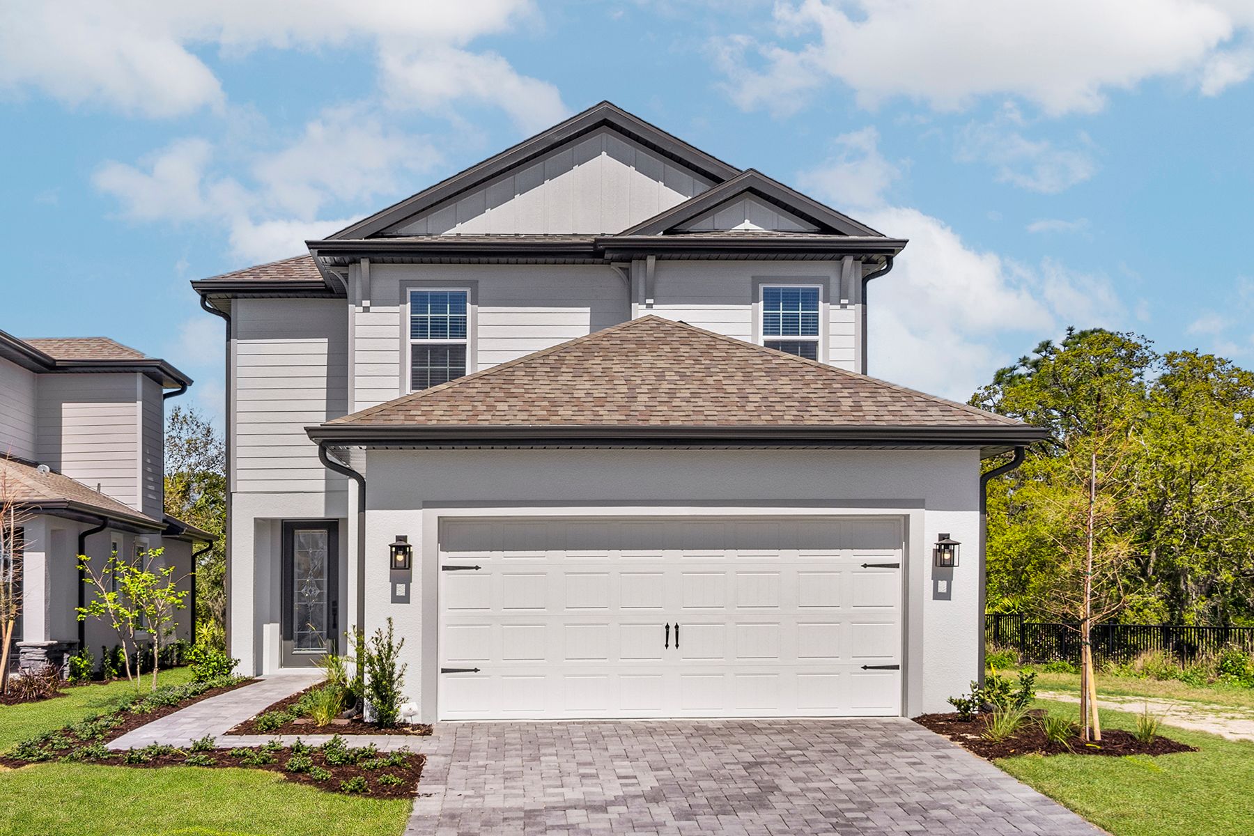 Exterior of the Togo plan with a beautiful walk way and professional landscaping