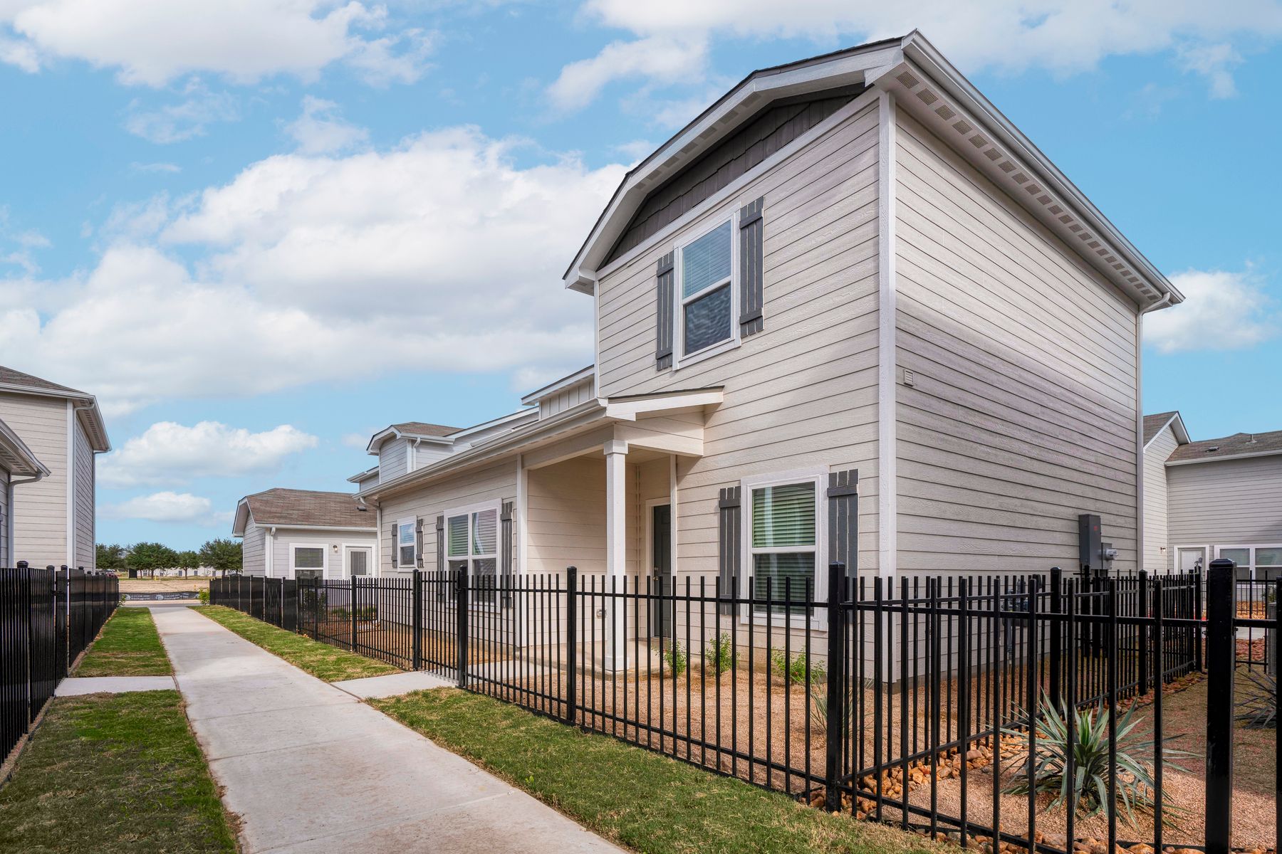Exterior of the Brantley, showcases the wrap-around fence and professional landscaping.