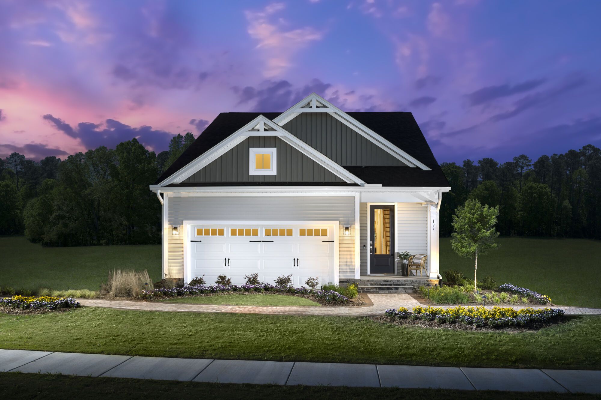 Exterior:Morgan model home at twilight - Farmhouse elevation