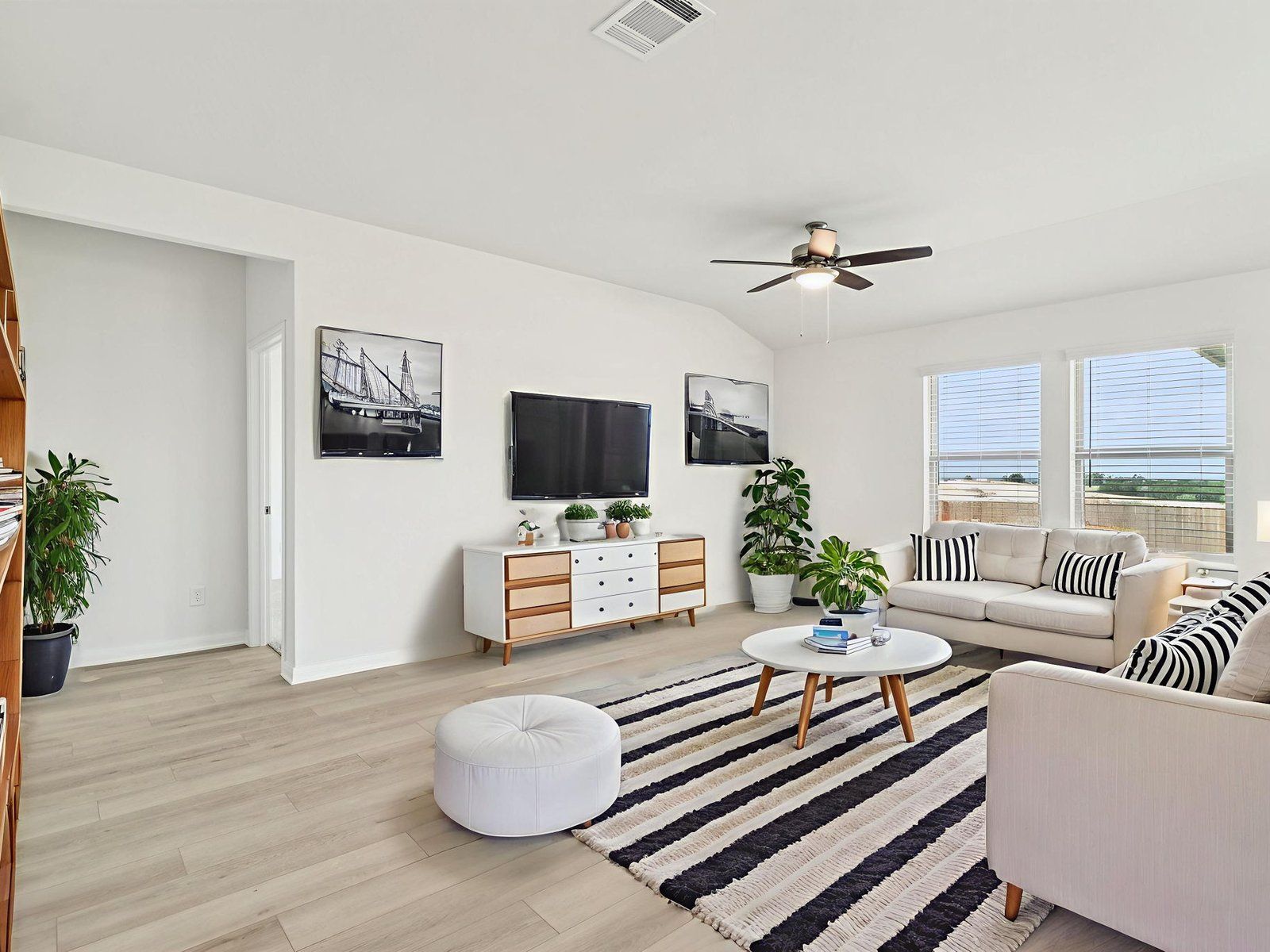 Virtually staged living room in the Fitzhugh floorplan at a Meritage Homes community.:Virtually Staged Living Room