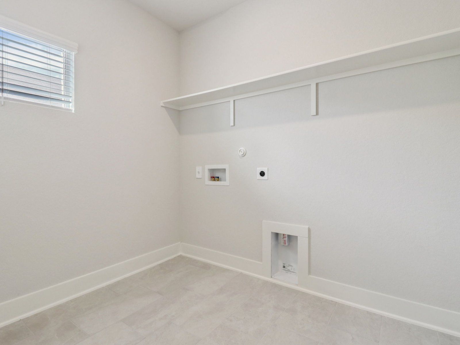 Laundry room in the Reynolds floorplan at a Meritage Homes community.:Laundry Room