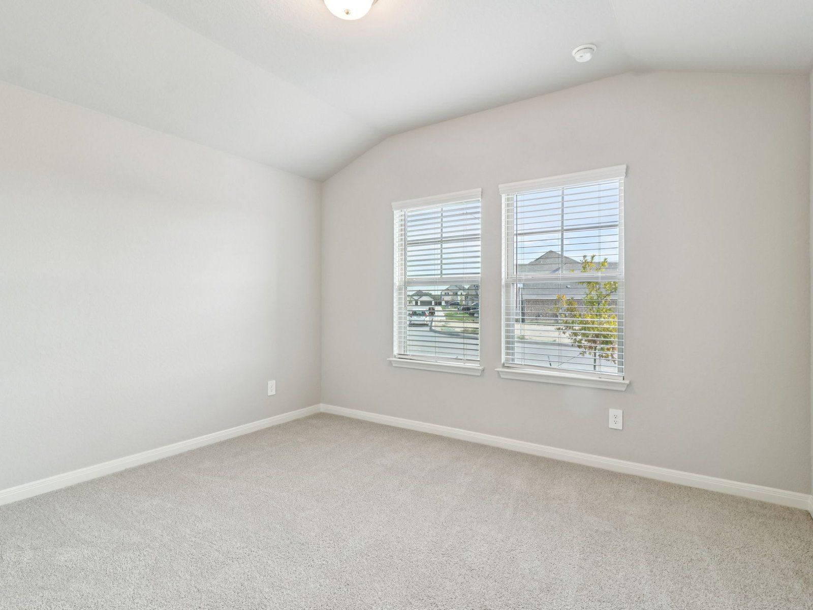 Guest Bedroom:Guest bedroom in the Henderson floorplan at a Meritage Homes community.