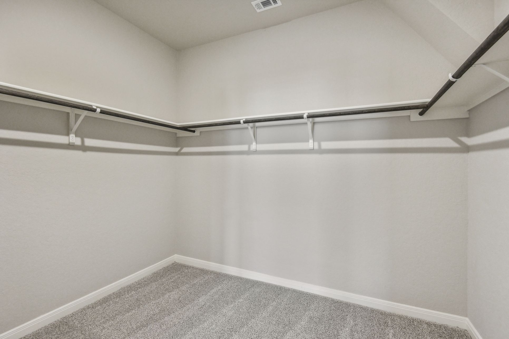 Primary Suite Walk-In Closet:Primary suite walk-in closet in the Callaghan floorplan at a Meritage Homes community.