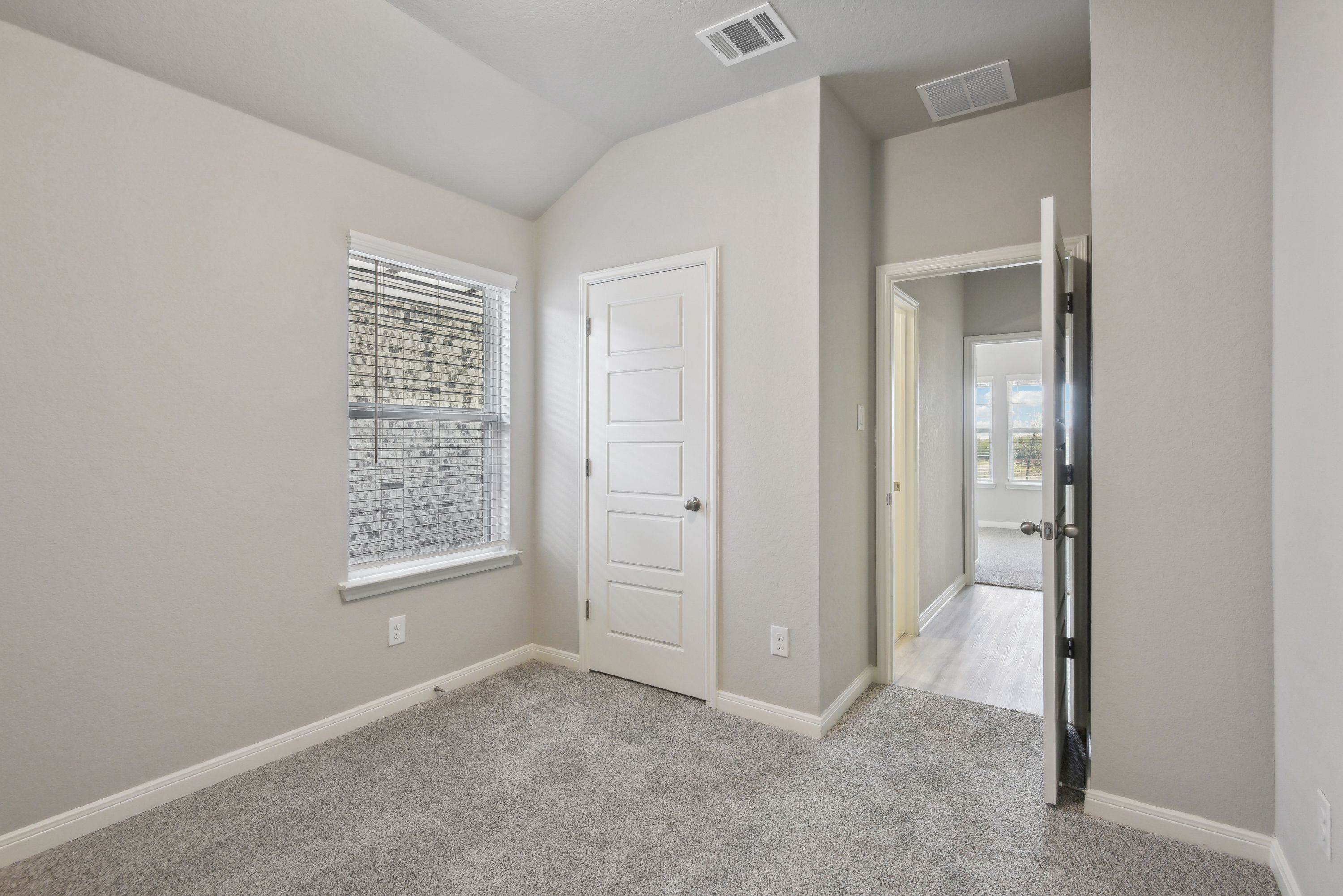 Guest Bedroom:Guest bedroom in the Callaghan floorplan at a Meritage Homes community.
