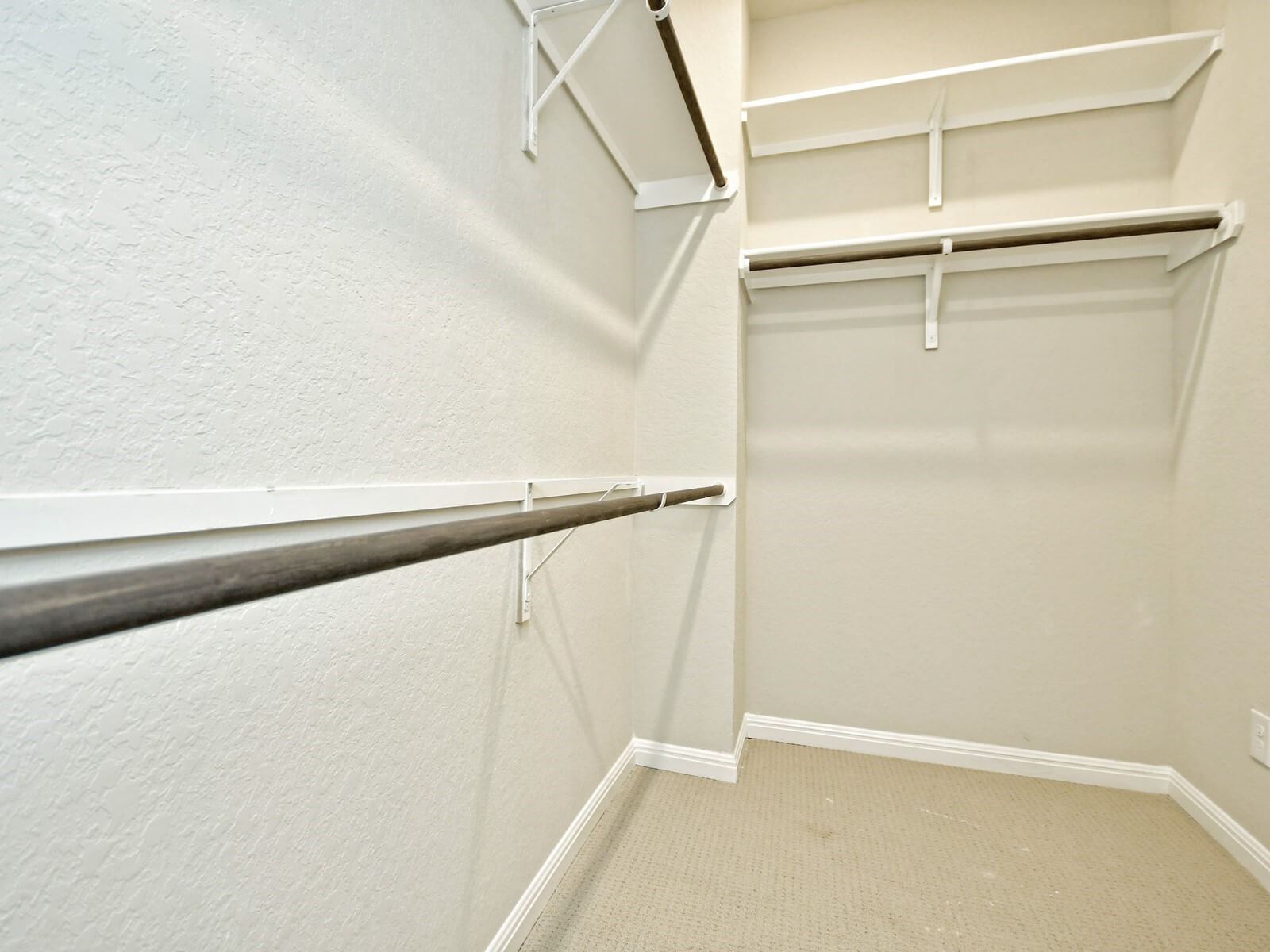 Primary Suite Walk-In Closet:Primary suite walk-in closet in the San Saba floorplan at a Meritage Homes community.