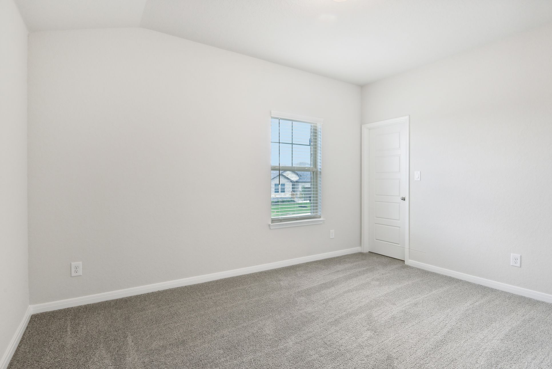 Guest bedroom in the McKinnon floorplan at a Meritage Homes community.:Guest Bedroom