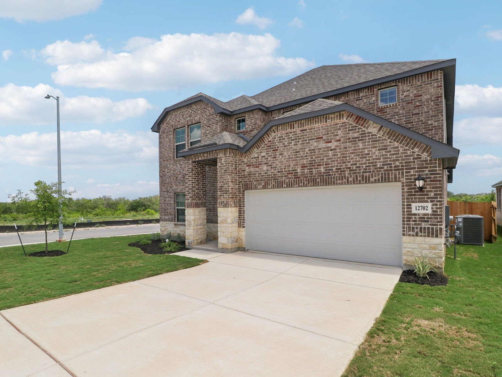 Front exterior of the Kessler floorplan at a Meritage Homes community in San Antonio, TX.:Front Exterior