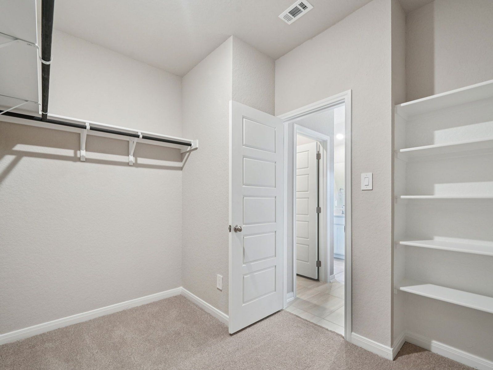Primary suite walk-in closet in the Allen floorplan at a Meritage Homes community.:Primary Suite Walk-In Closet