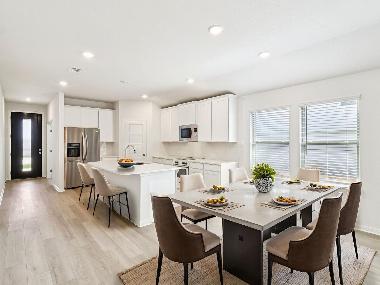 Virtually staged dining and kitchen in the Allen floorplan at a Meritage Homes community.:Virtually Staged Dining and Kitchen