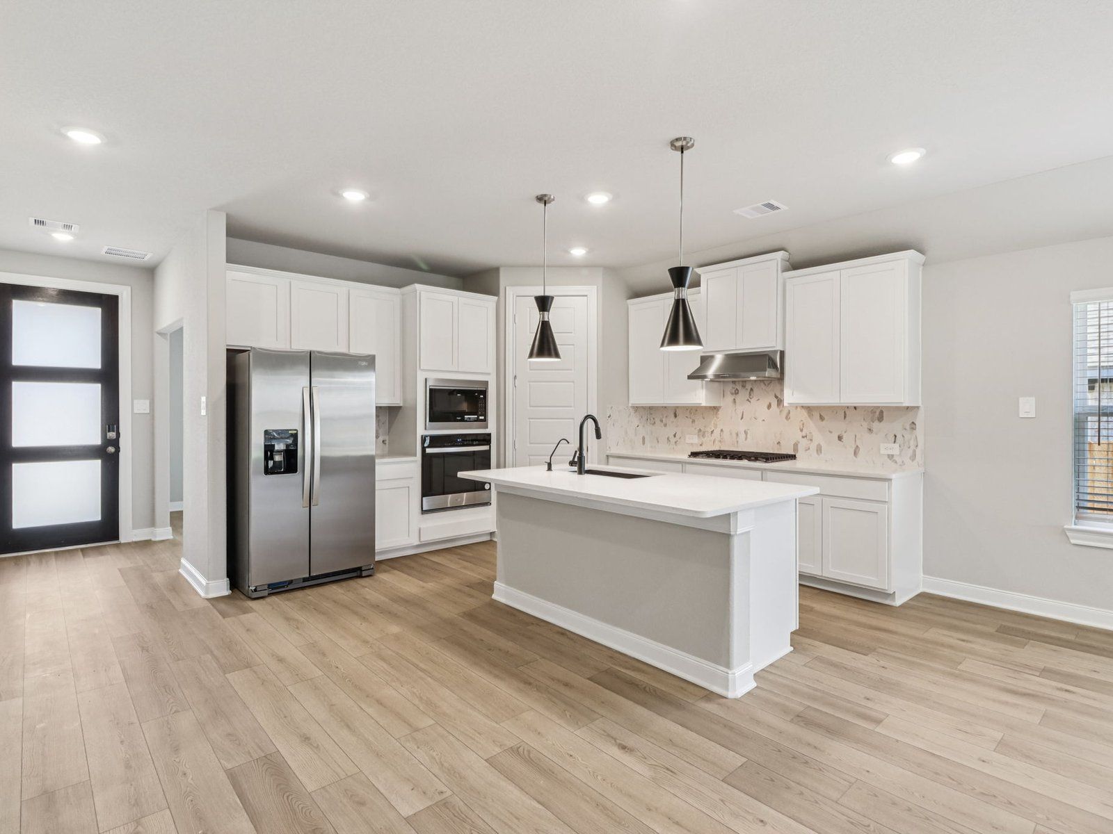 Kitchen:The Oleander floorplan in Pine Lake Cove of Montgomery, TX.