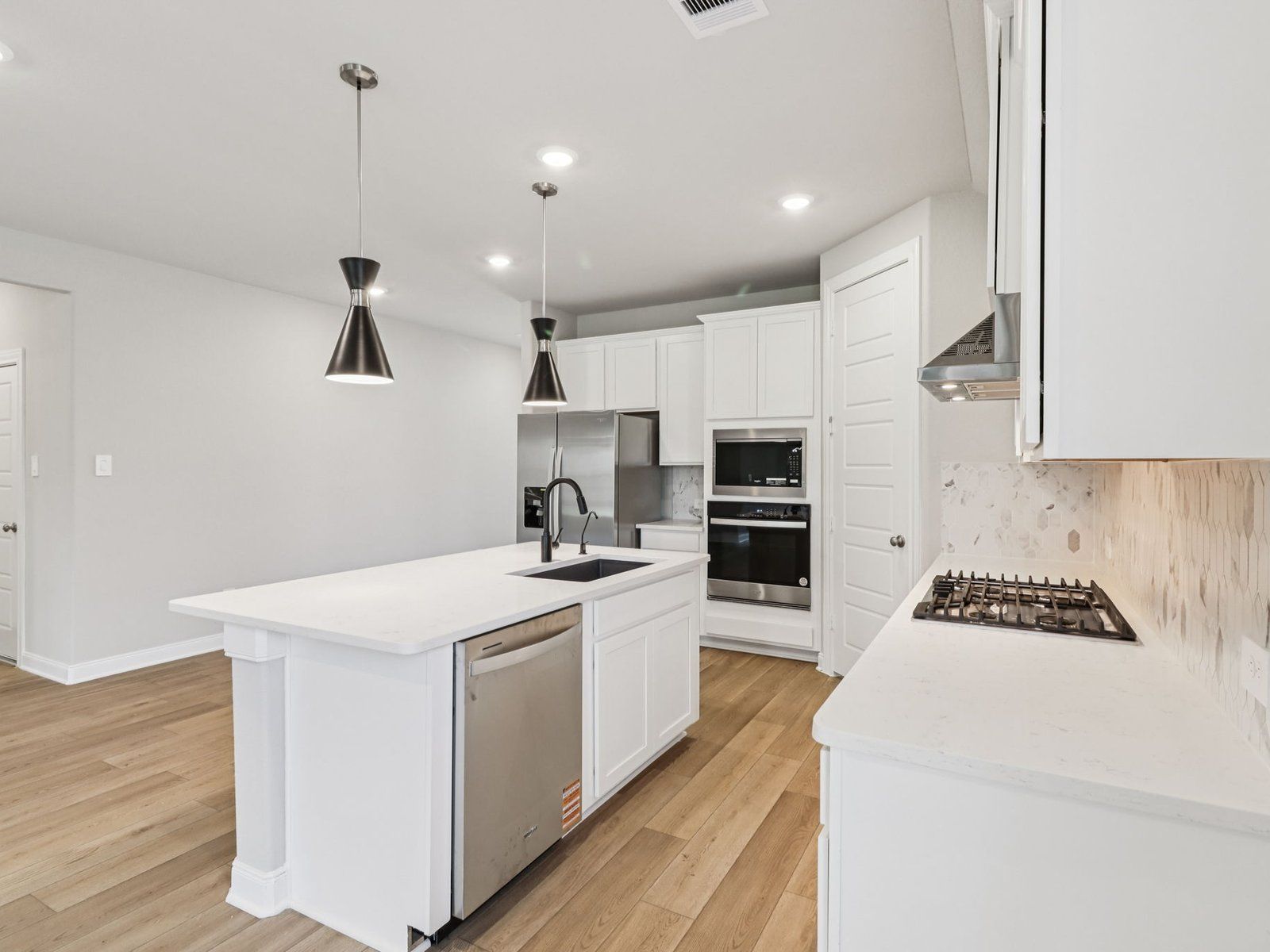 Kitchen:The Oleander floorplan in Pine Lake Cove of Montgomery, TX.