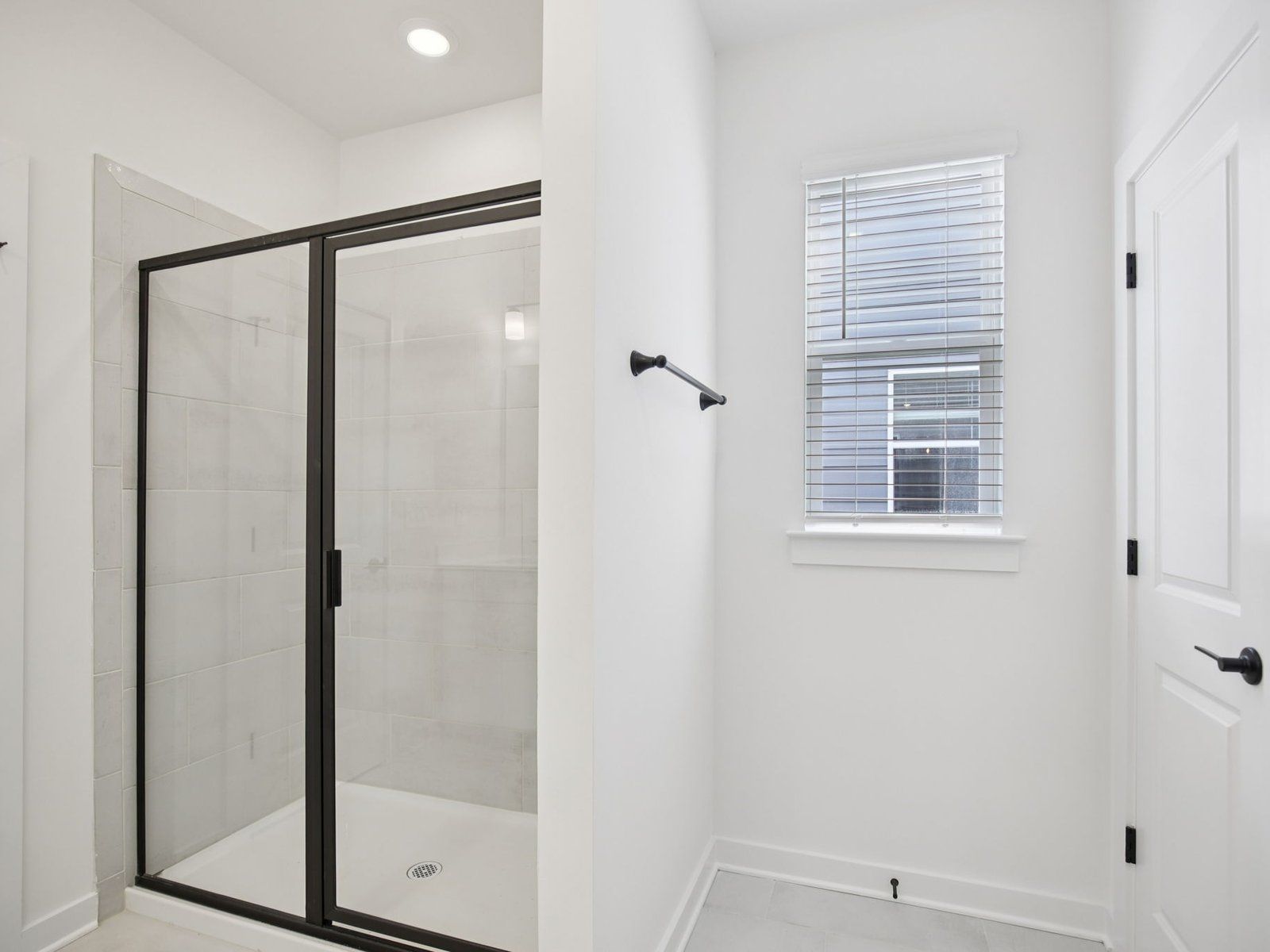 The primary bathroom offers dual vanity sinks and a walk-in shower.:Primary Bathroom