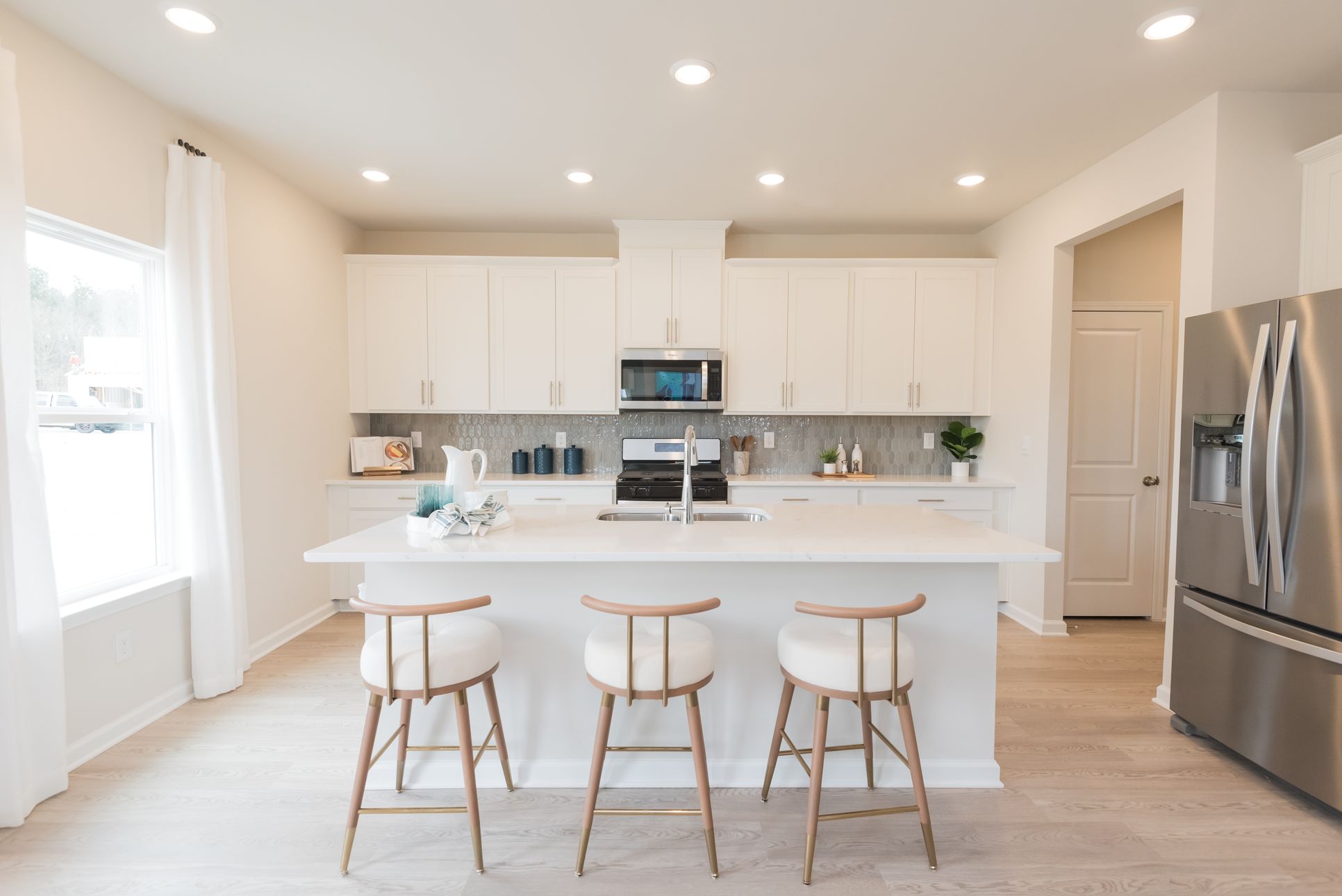 Kitchen:The Taylorsville floorplan with the Lush White interior package modeled at Parkside at Grayson.