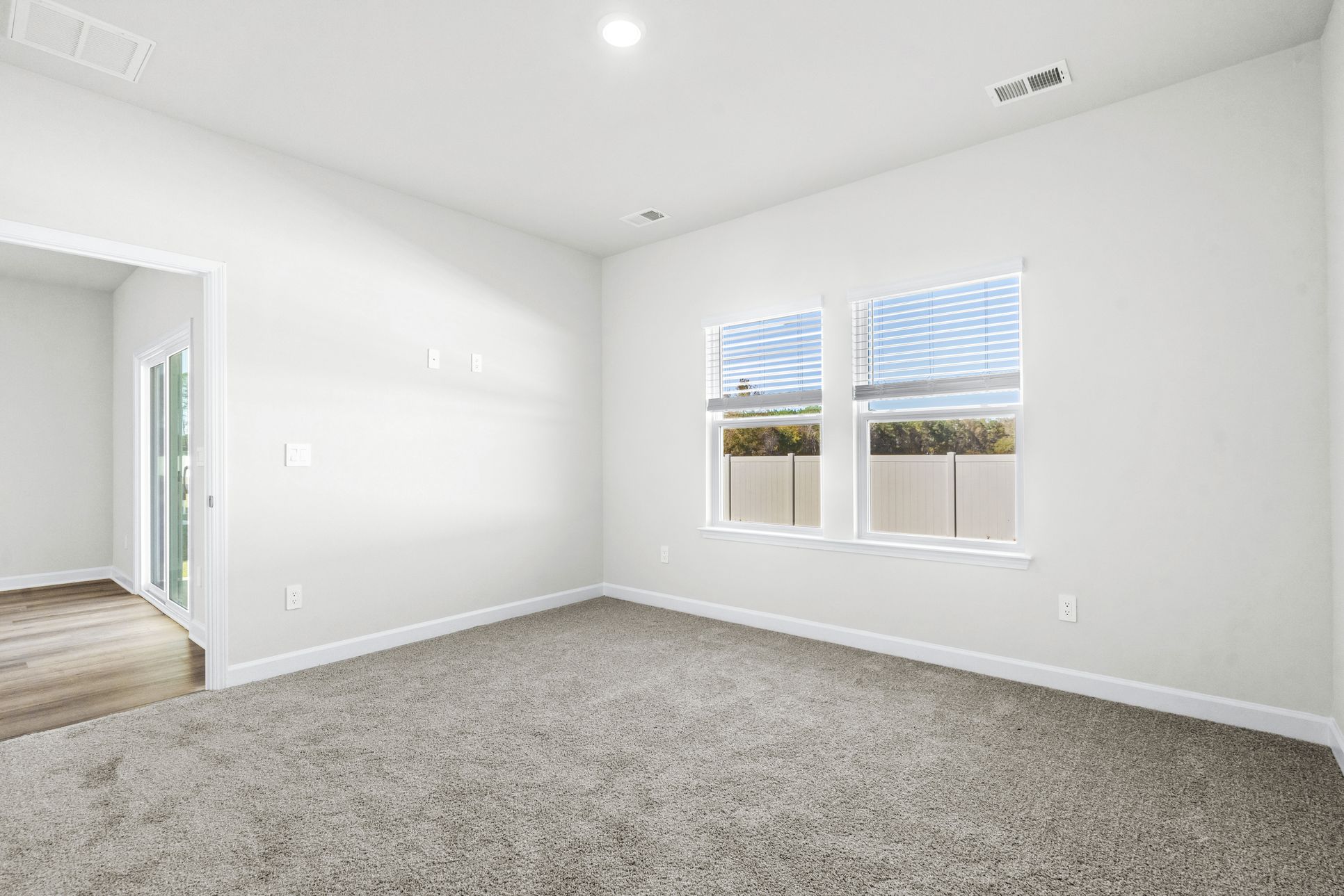 Primary Bedroom:Relax and recharge in the spacious, light-filled primary suite.