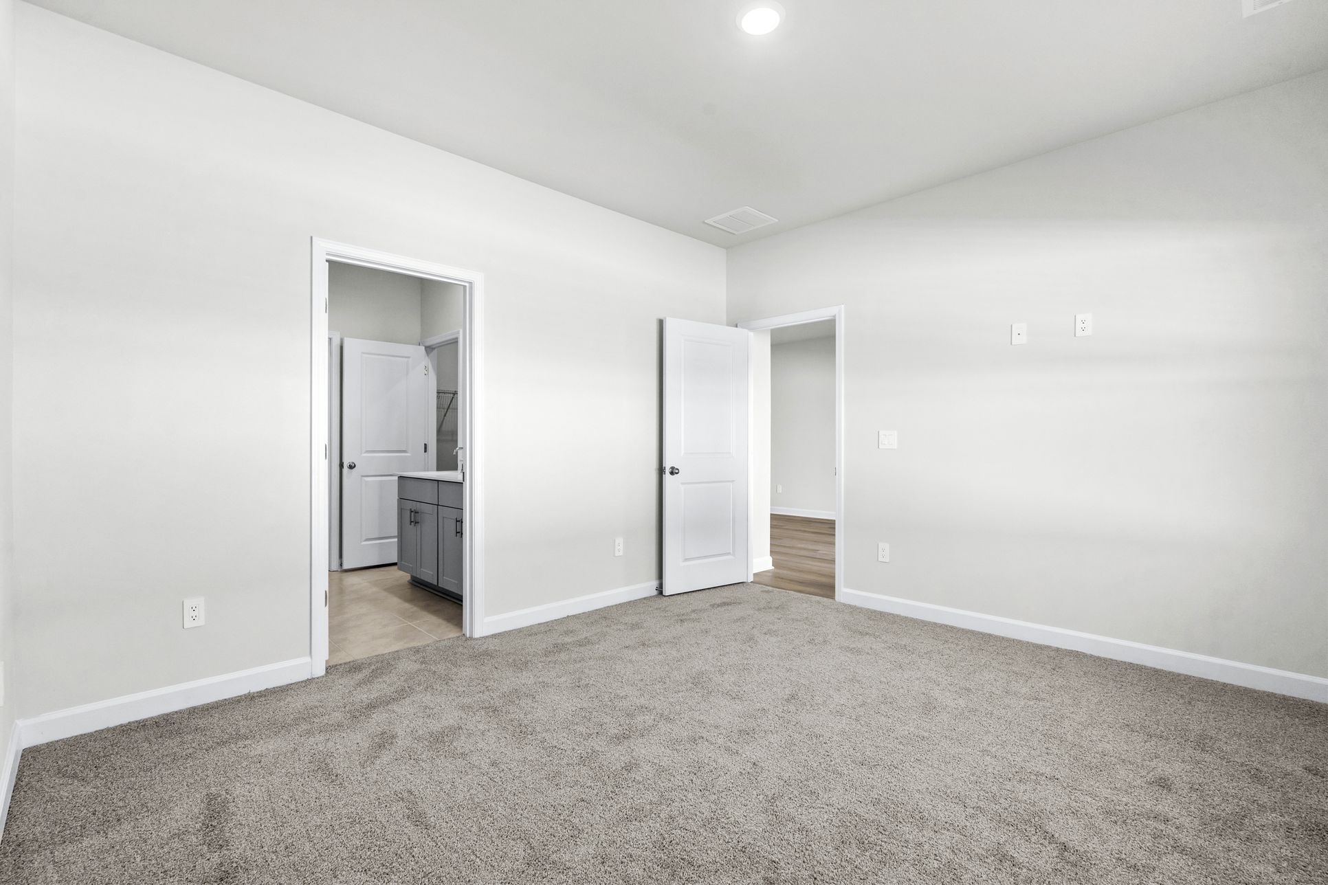 Primary Bedroom:The primary suite leads to a well-appointed private bathroom.