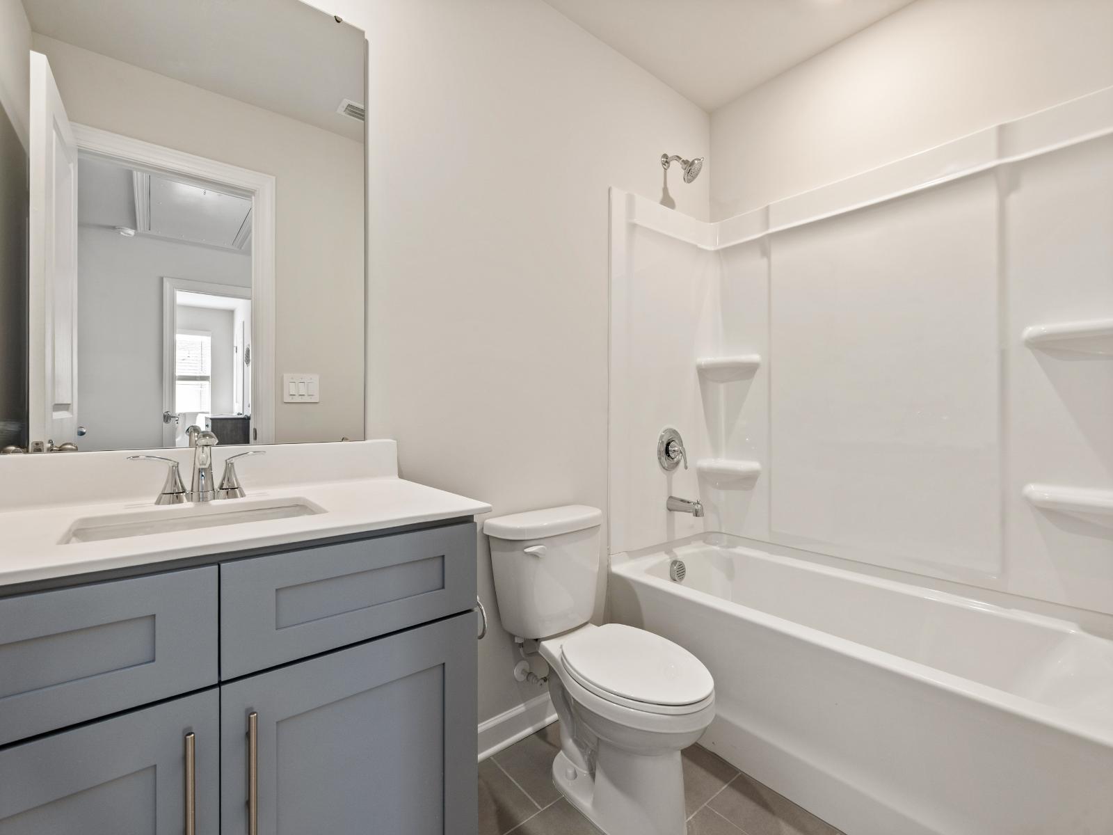 The secondary bath offers a space for guests to get ready.:The secondary bath offers a space for guests to get ready.