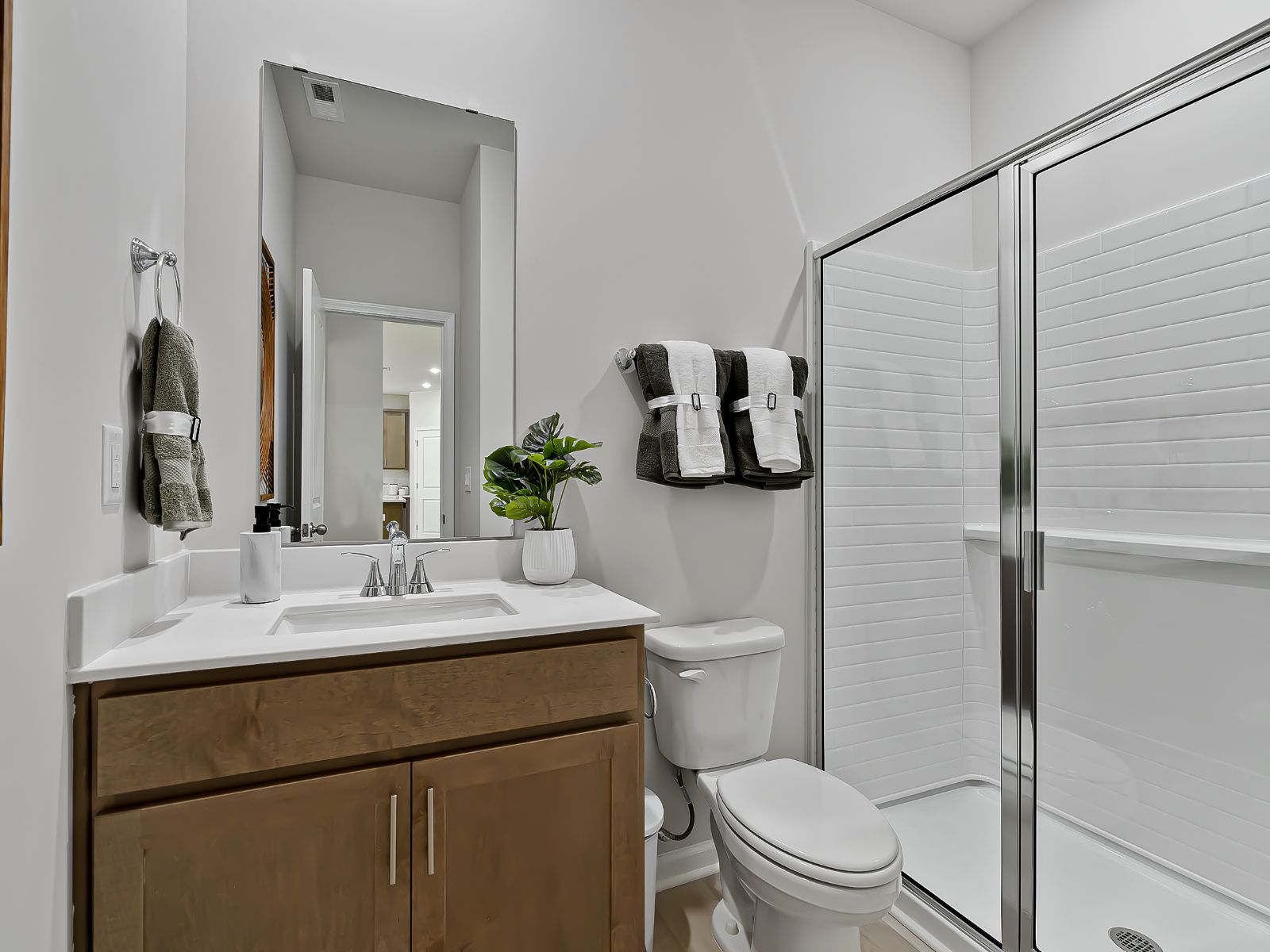 RAL_CadenceMeadows_Chatham_Bath3_3805RosebushDr_Model.jpg:Guest can enjoy their own full bathroom adjacent to the downstairs bedroom.