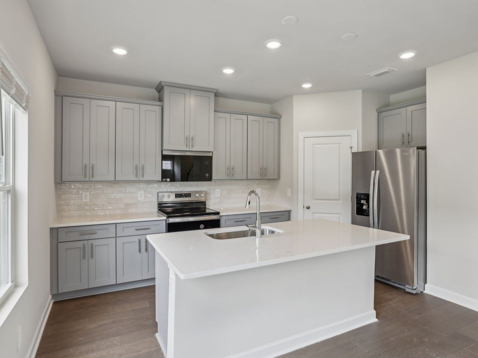 Kitchen:The oversized kitchen island is a perfect bar counter for additional seating.