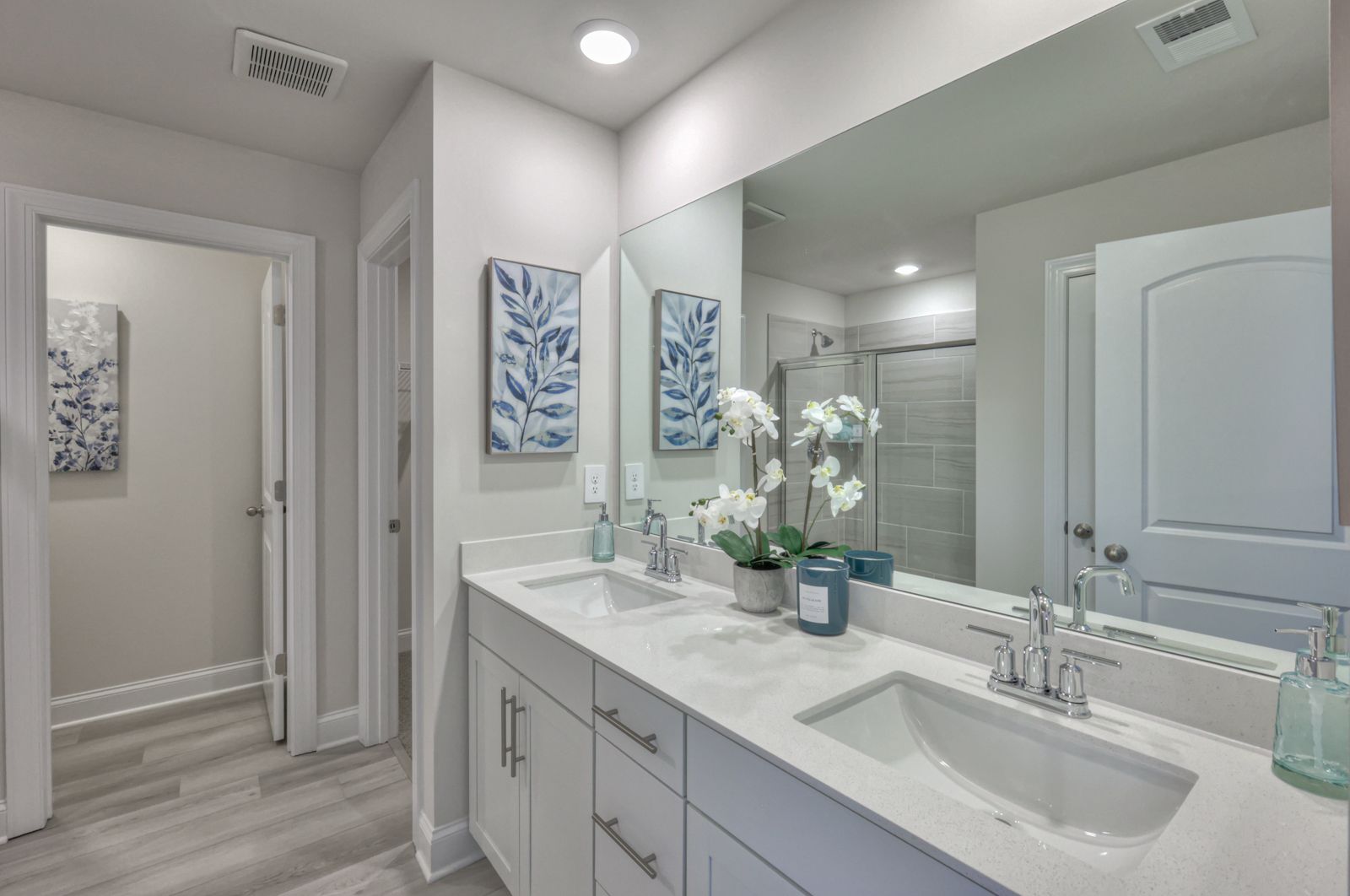 The primary bathroom offers dual vanity sinks and a walk-in shower.:Primary Bathroom