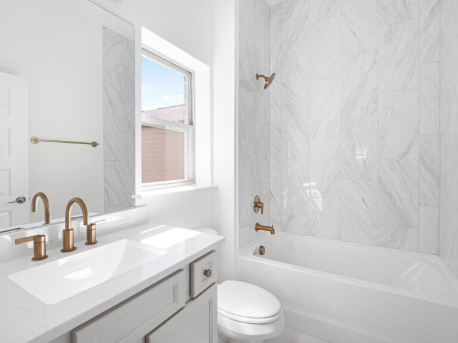 The primary bathroom offers a compact, functional design with a bathtub, toilet, and sink.:The primary bathroom offers a compact, functional design with a bathtub, toilet, and sink.