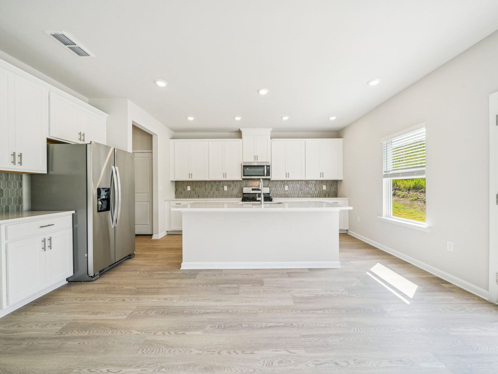 The Taylorsville floorplan with the Lush White interior package.:Kitchen