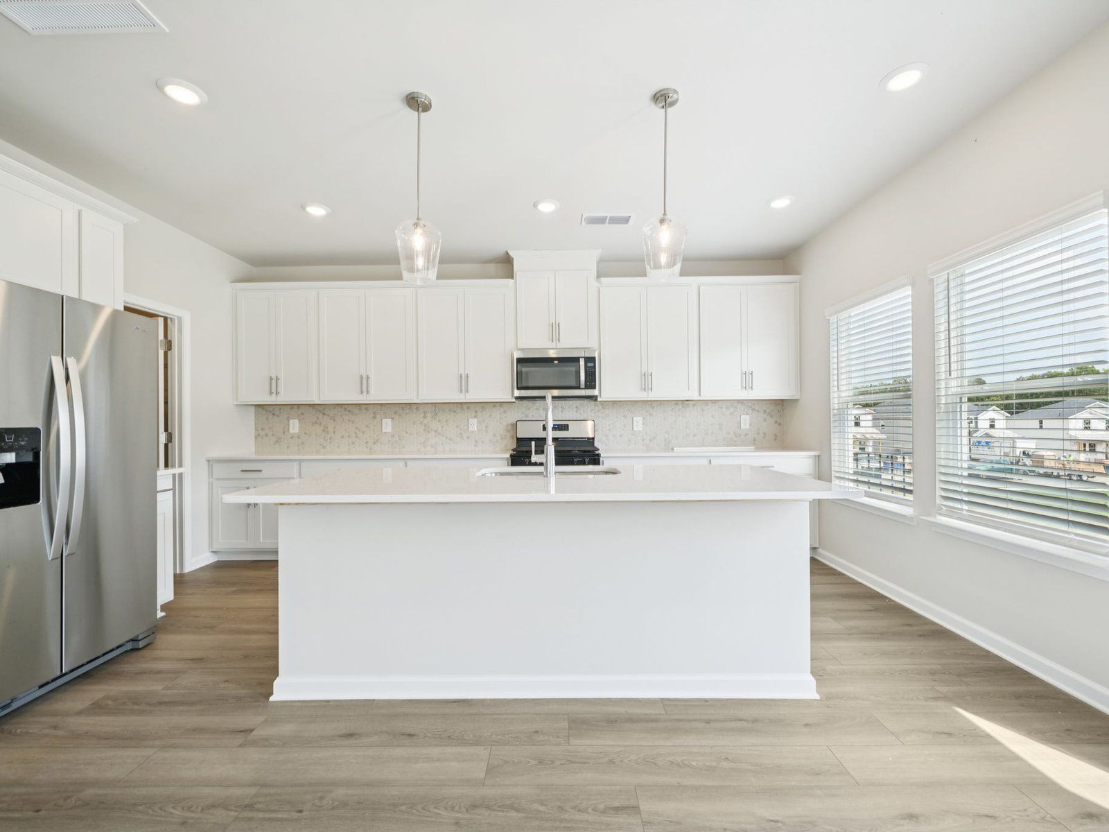 The Dakota floorplan with the Elemental White interior package.:Kitchen