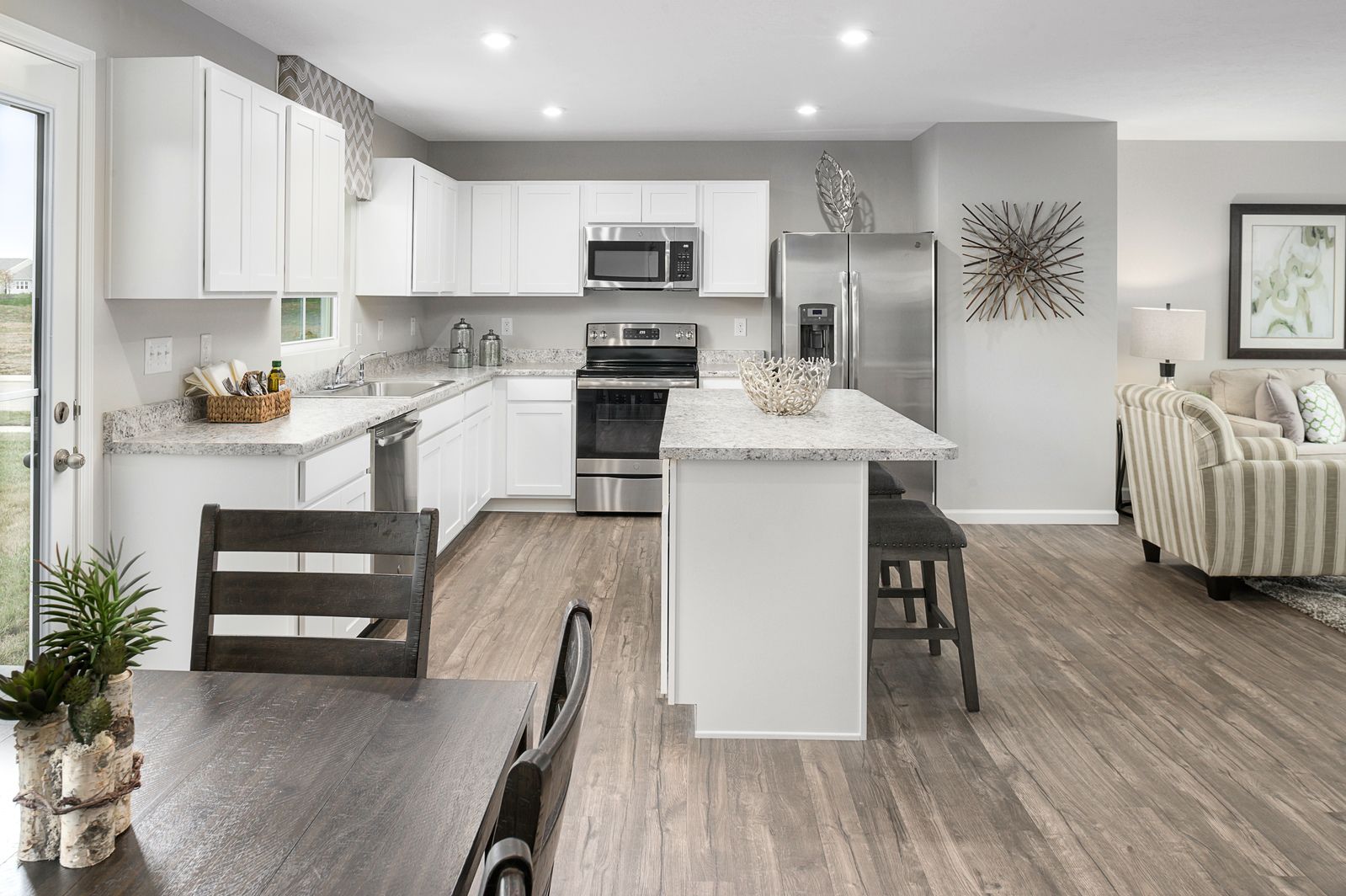 FRESH, OPEN KITCHEN WITH LARGE ISLAND AND INCLUDED APPLIANCES:?Your brand-new kitchen comes with a large island, bright window over the sink, a refrigerator, stove, and microwave, PLUS your washer and dryer, you are all set!?