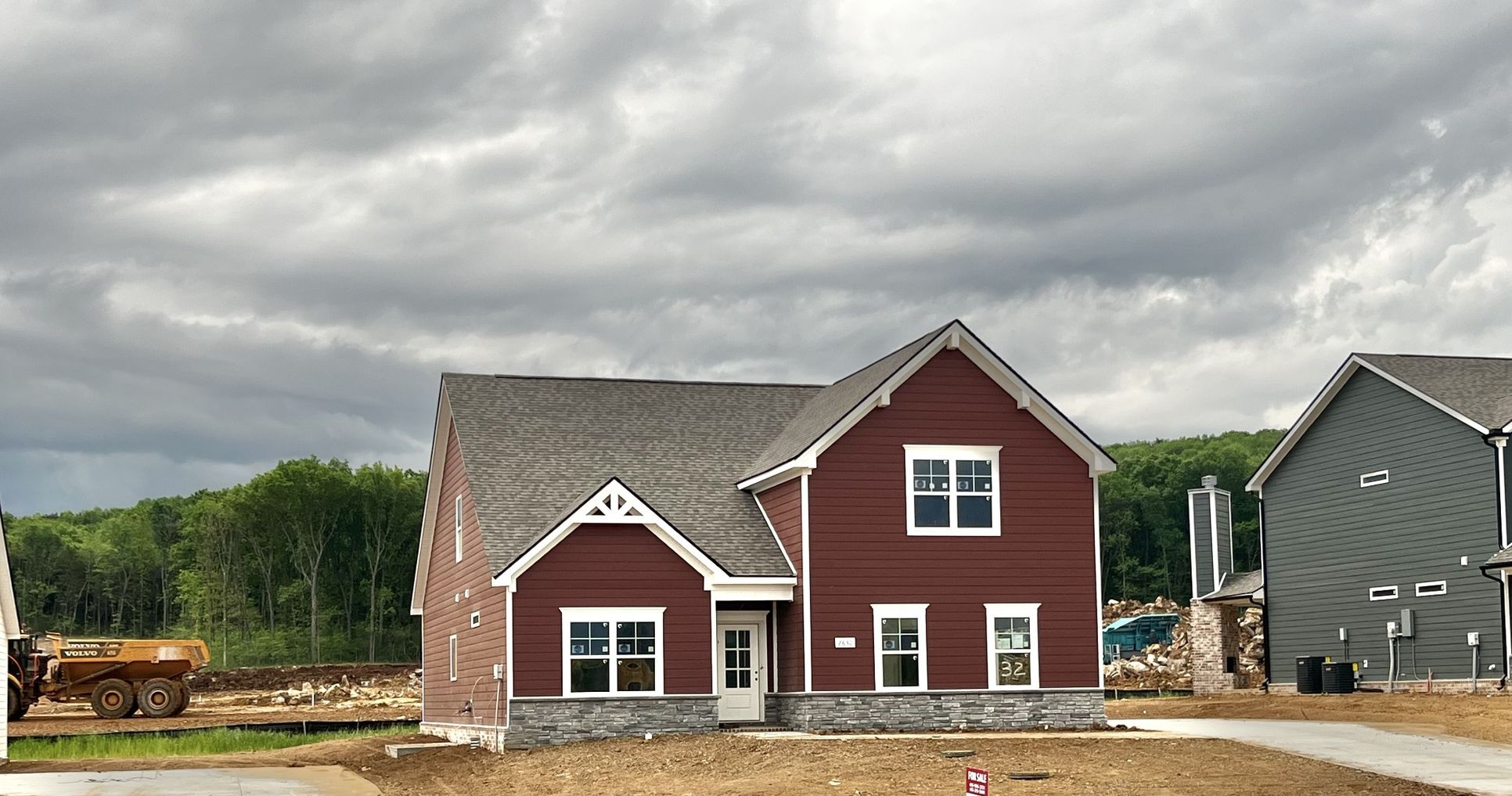 Exterior:Actual house with side entry garage and Red James Hardie Siding.