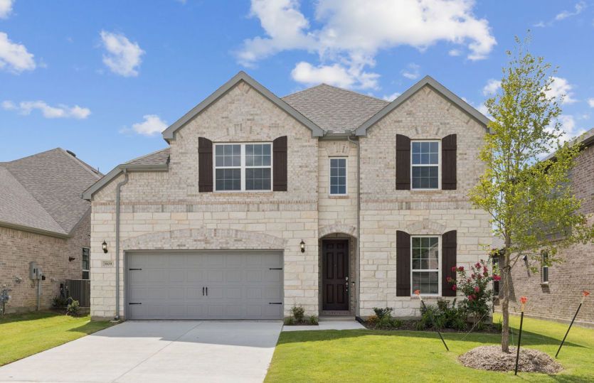 Exterior:Exterior C with shutters, stone accents, and 2-car garage with additional storage *Model representation