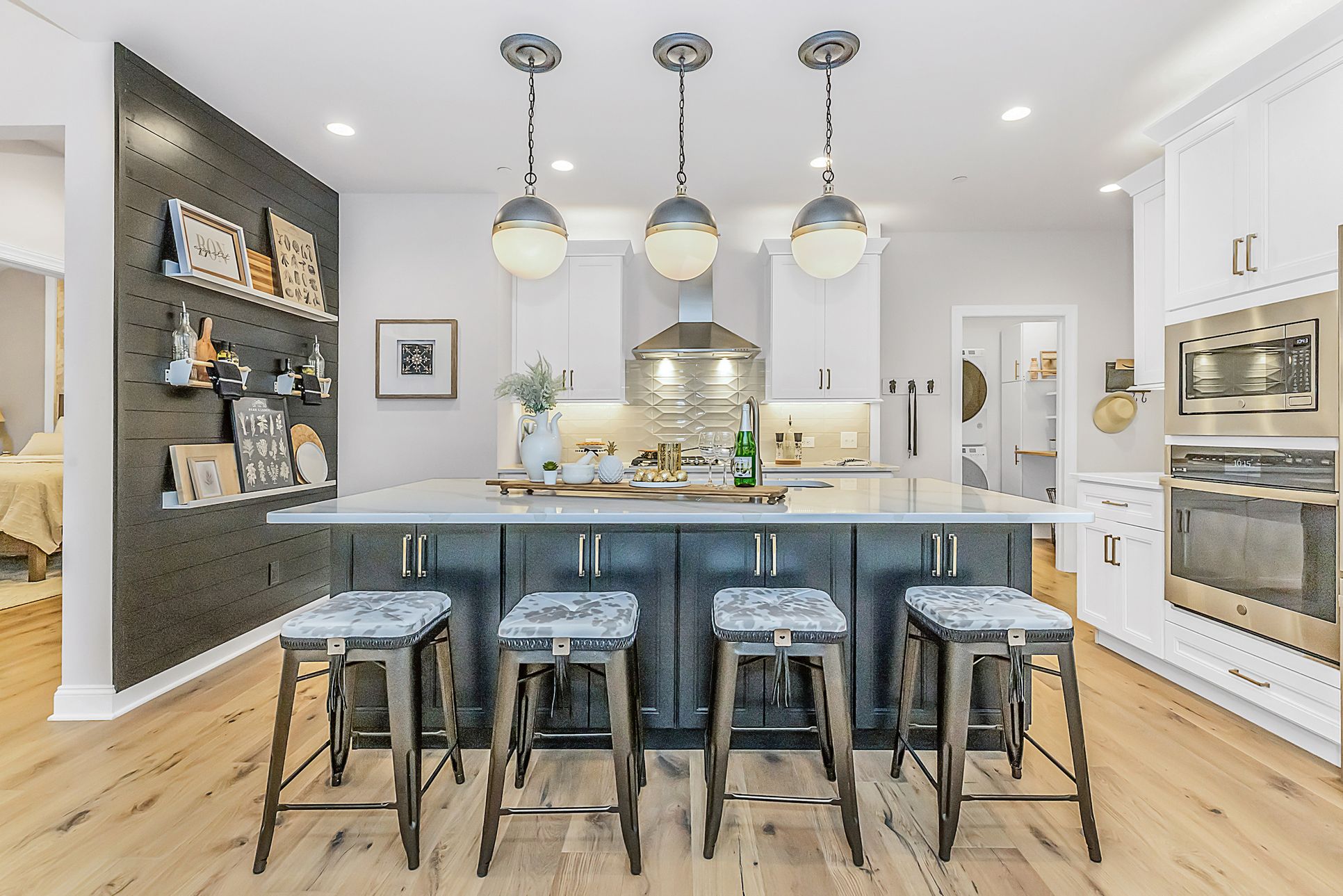 luxury, fully furnished kitchen with double oven, large kitchen island and range with hood