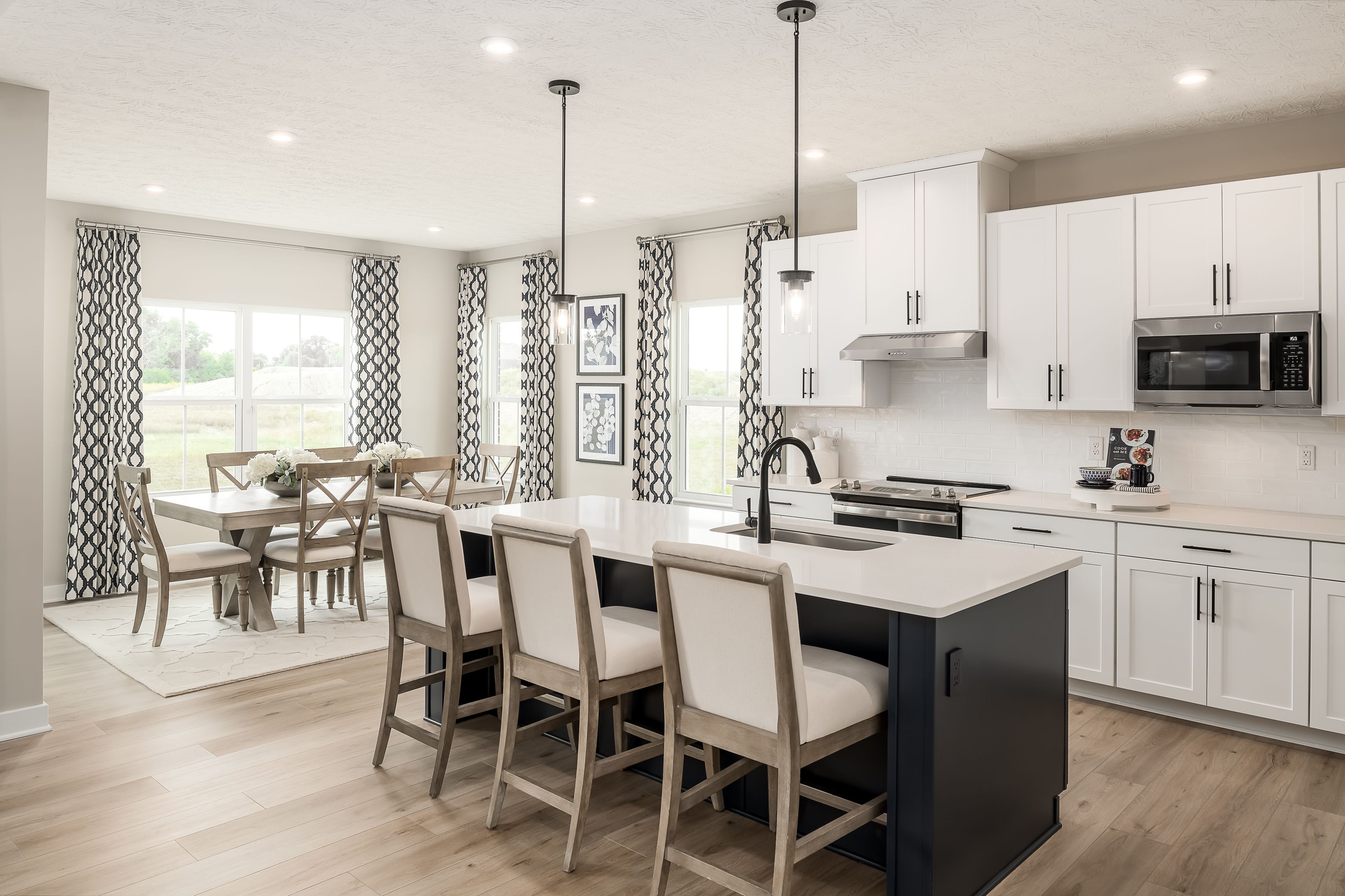 The kitchen features you want are included in the base price of your home:Your new kitchen includes a 6&rsquo;+ island, upgraded cabinets, quartz countertops and stainless-steel appliances &ndash; all included in the base price of your home!