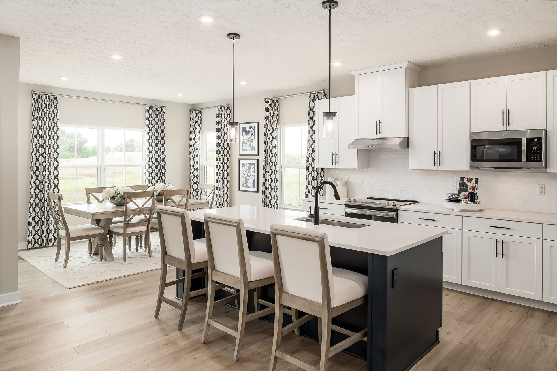 The kitchen features you want are included in the base price of your home:Your new kitchen includes a 6’+ island, upgraded cabinets, quartz countertops and stainless-steel appliances – all included in the base price of your home!