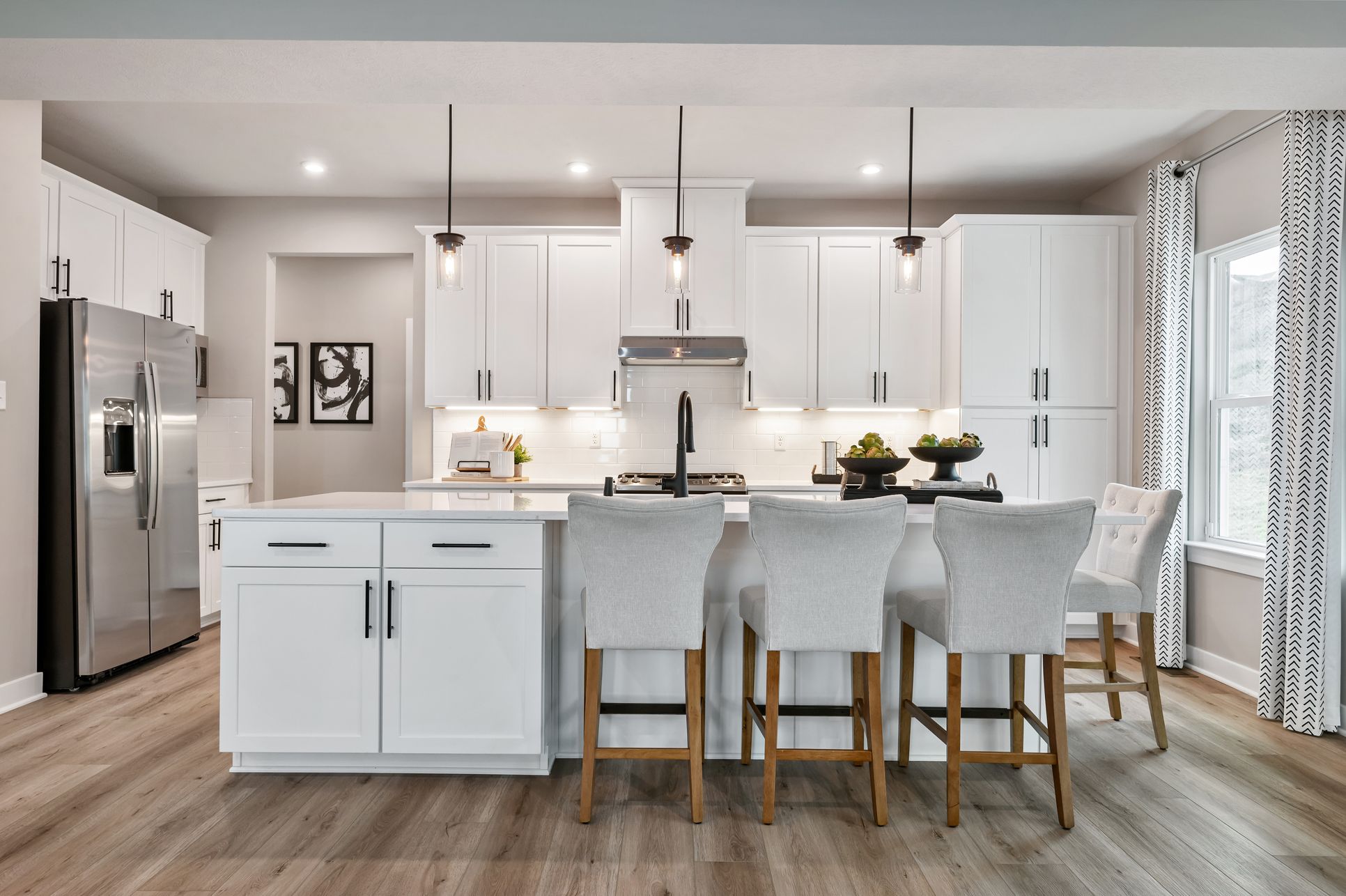 A warm, upscale kitchen designed around a stunning island.