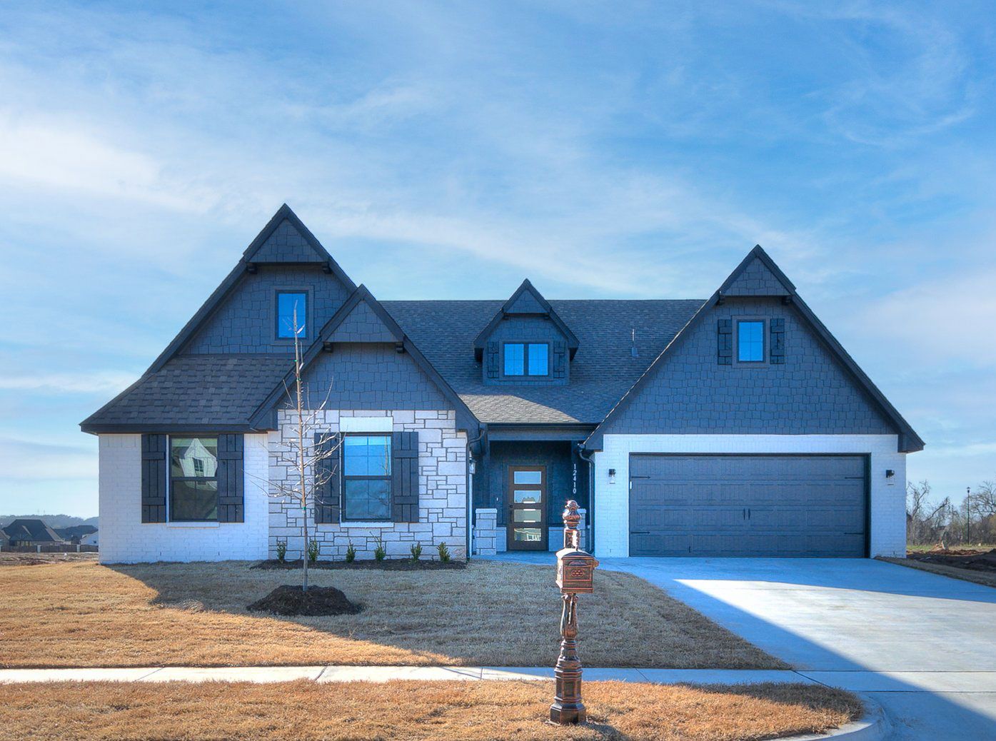Striking black and white on this home with a stone accent and wood stained modern door make this ...:Bailey Premier Elevation