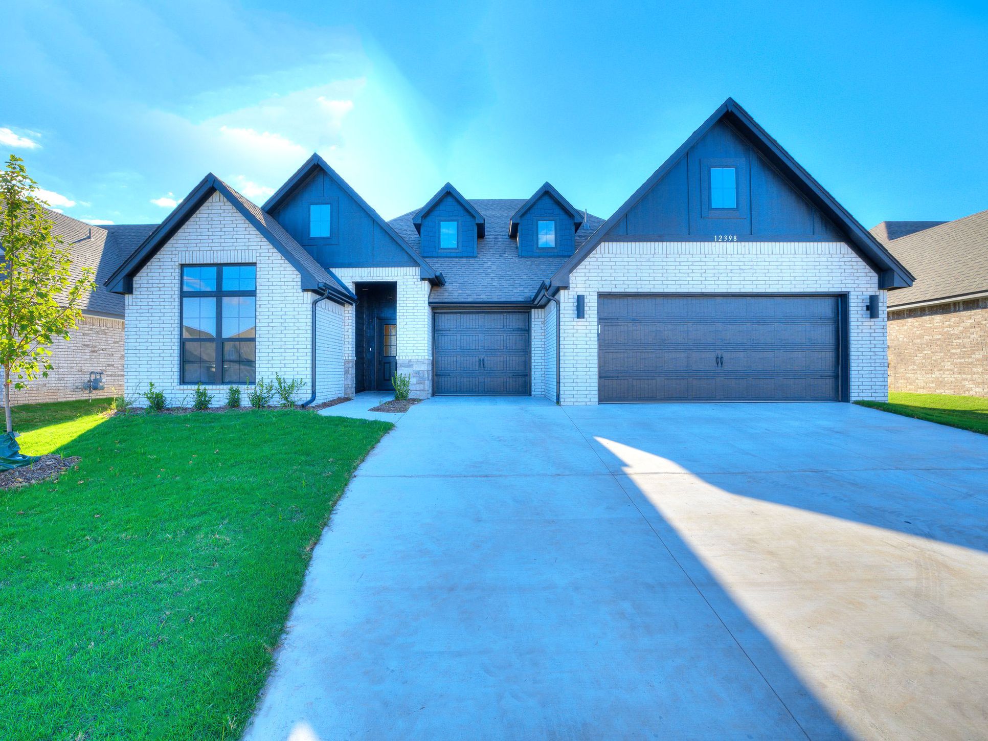 This modern black James Hardie Siding against crisp white brick give this 4 bedroom home a striki...:Dawson Classic Elevation