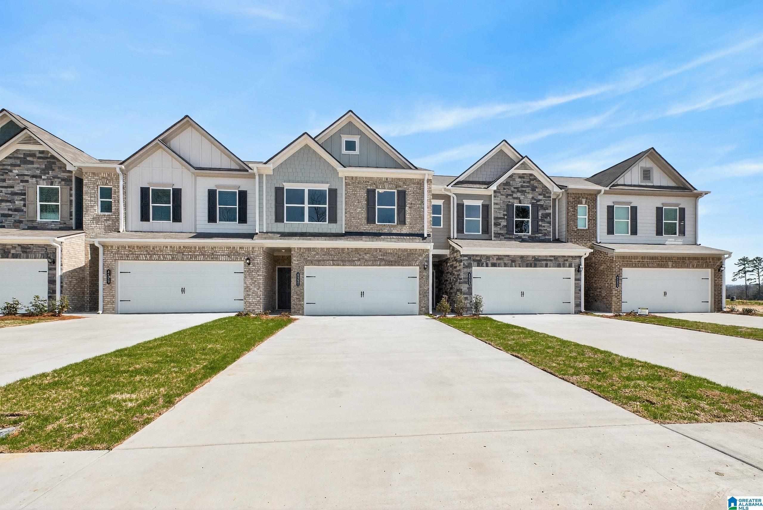 Exterior:Craftsman inspired home with a garage, board and batten siding, and concrete driveway