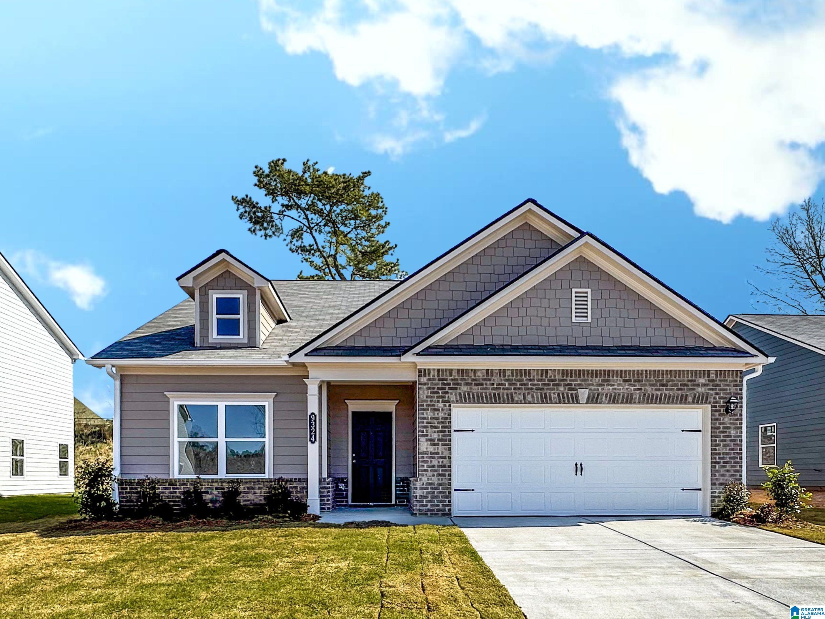 Exterior:View of front facade featuring a garage, driveway, a front yard, covered porch, and a shingled roof