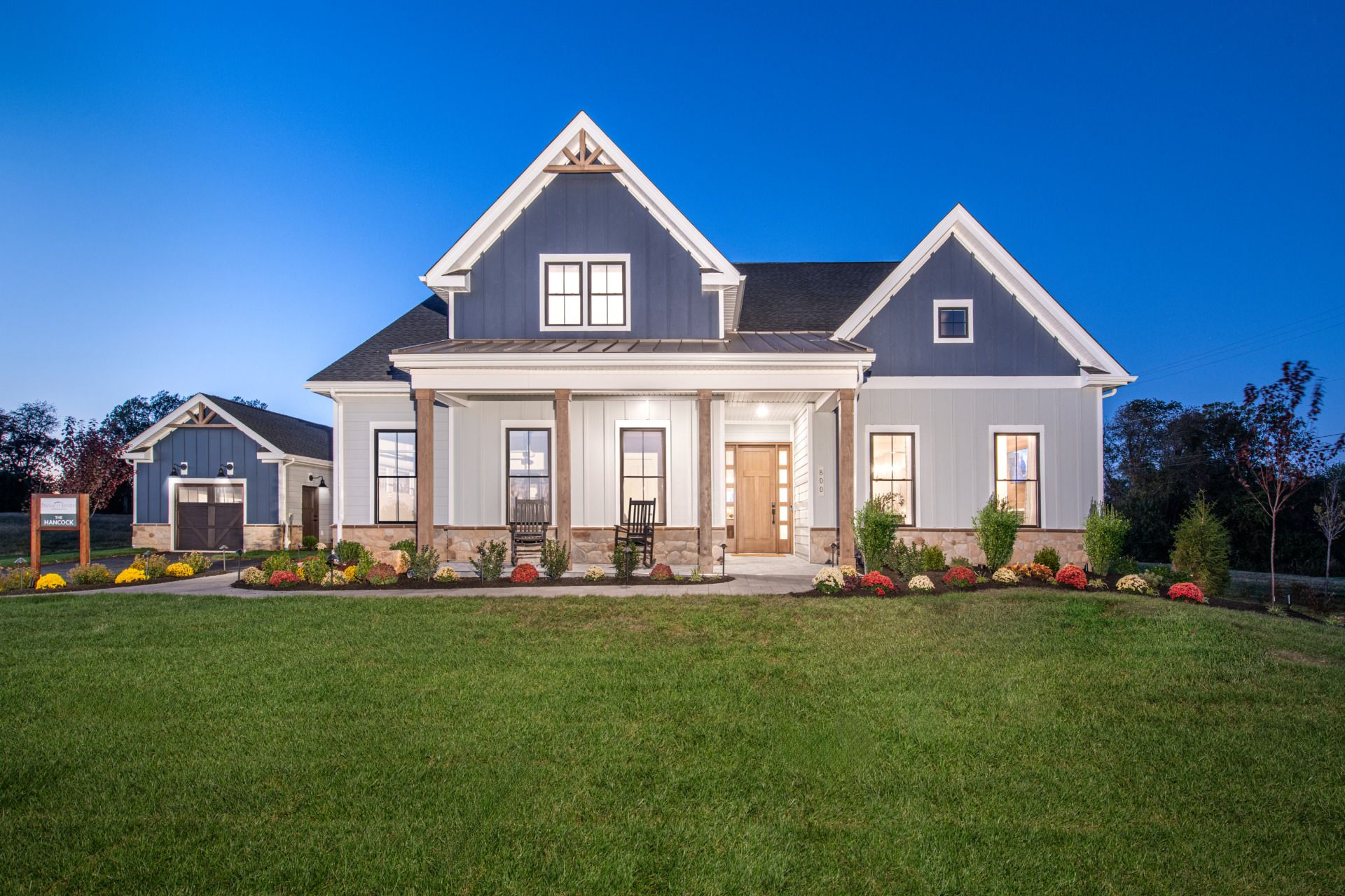 The Pinnacle Estates Hancock Rustic Farmhouse Front Elevation Dusk