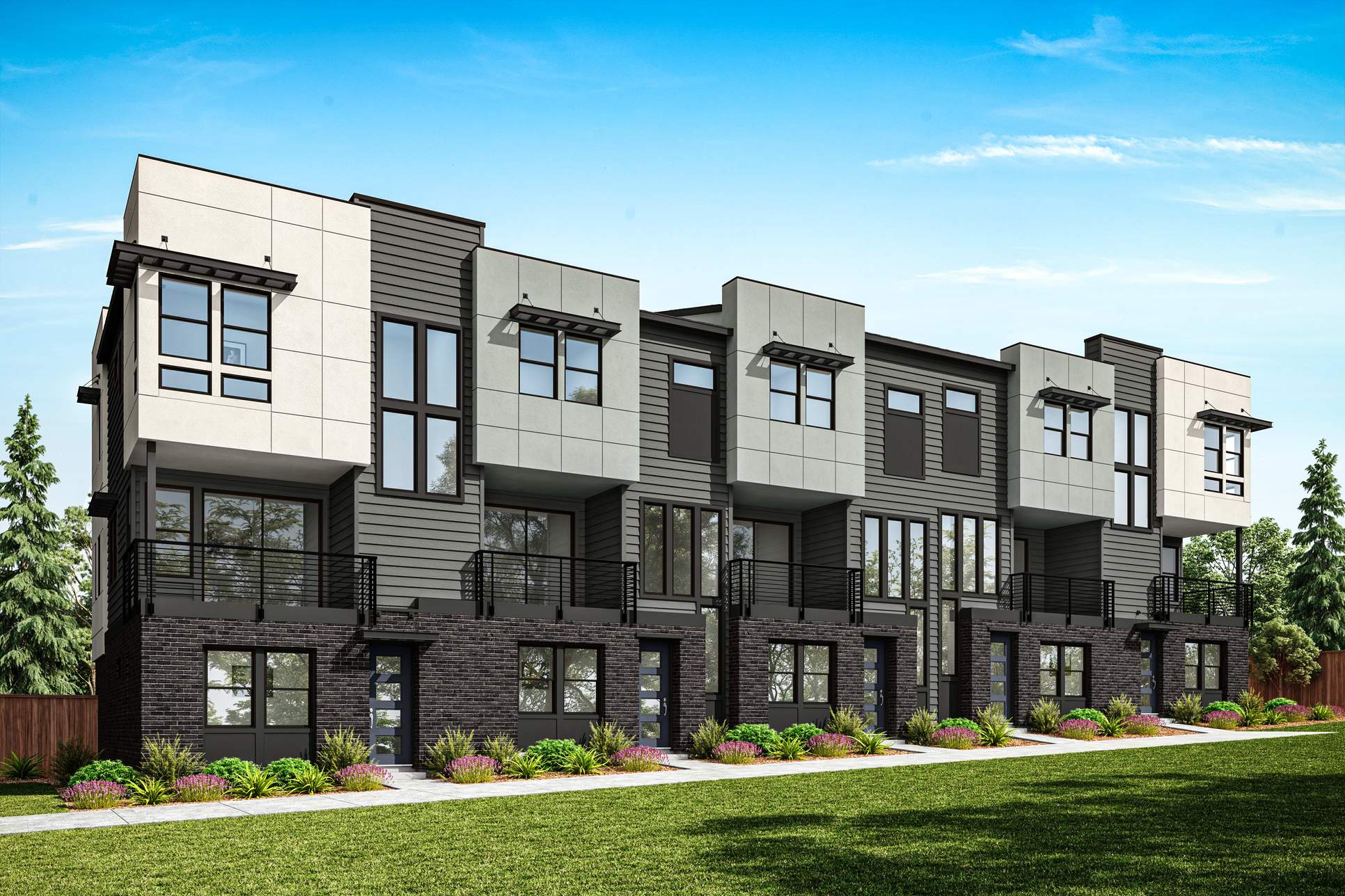 Arborstone_-_Bldg_9_-_D-5_TH_03_ohahjf:A modern multi-story townhouse complex with a well-manicured lawn and landscaping in the foreground, set against a clear blue sky in the background.