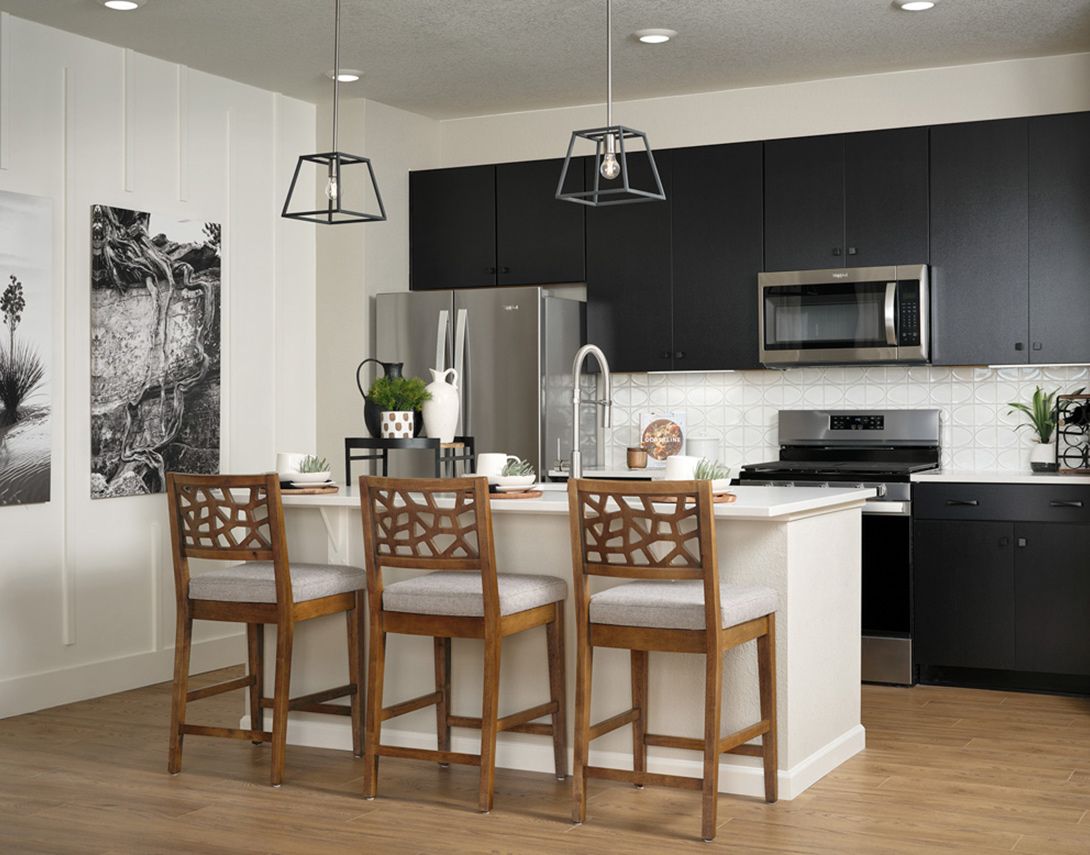 Plan A | Kitchen:Explore culinary endeavors in a gourmet kitchen elevated by white quartz counters, decorative backsp