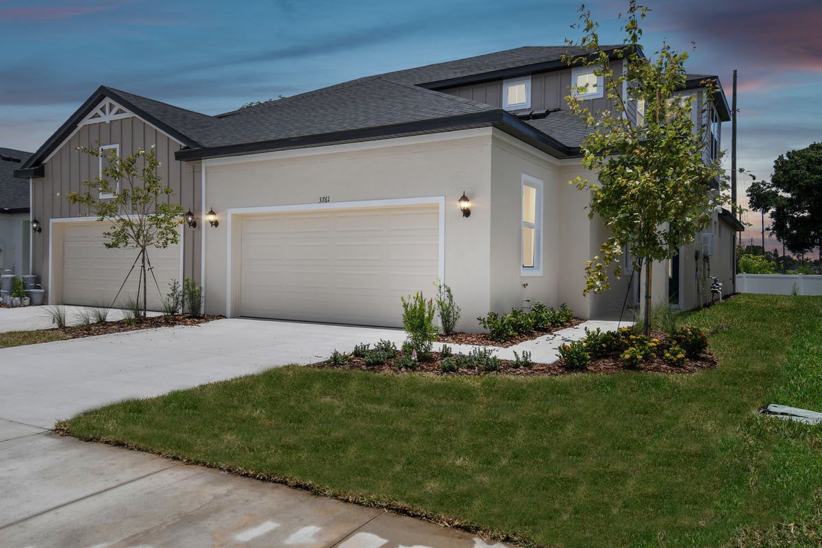 Jewel Luxury Paired Villa - Farmhouse - Front Exterior View at Dusk:Jewel new construction luxury paired villa in Sun City Center, Fl by William Ryan Homes Tampa